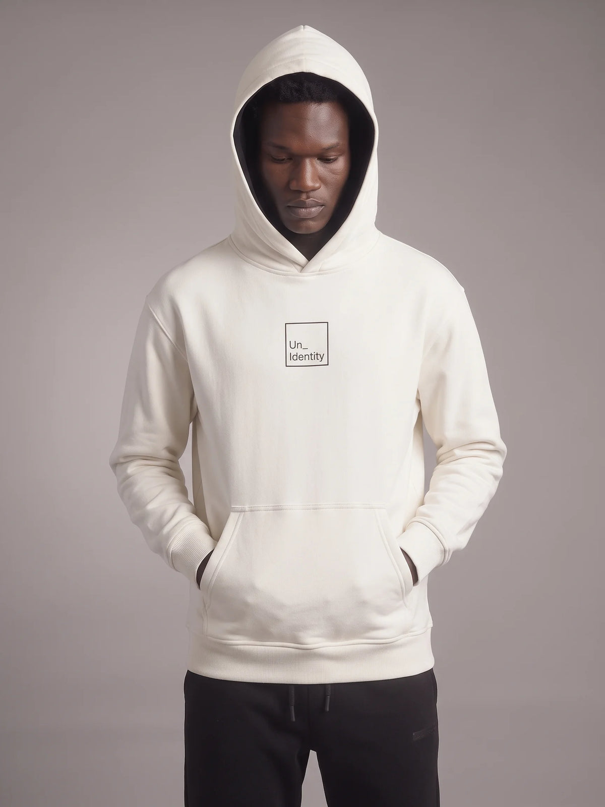 White regular fit hoodie, Unidentity Core Regular Fit Hoodie, front view on man with hood up and the minimal square logo, organic cotton #color_white