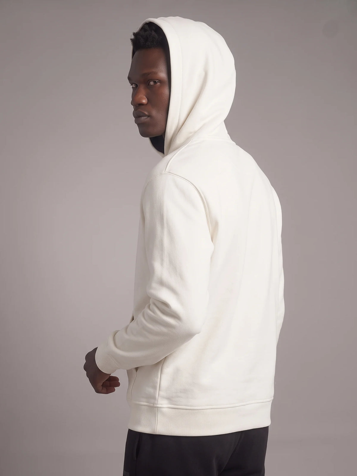 White heavyweight hoodie, Unidentity Core Hoodie, back view on man with hood up showing the ribbed cuffs, 390gsm organic cotton #color_white