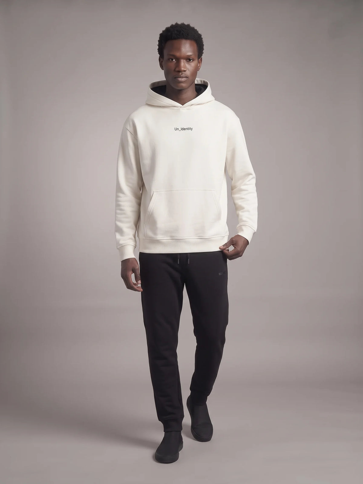White heavyweight hoodie in organic cotton, Unidentity Gem Hoodie, full-length front view on man with black Core Regular Fit Joggers, 390gsm #color_white