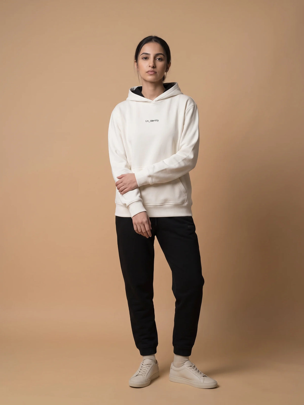 White regular fit hoodie, Unidentity Soul Hoodie, full-length front view worn by woman styled with black Core joggers, organic cotton #color_white