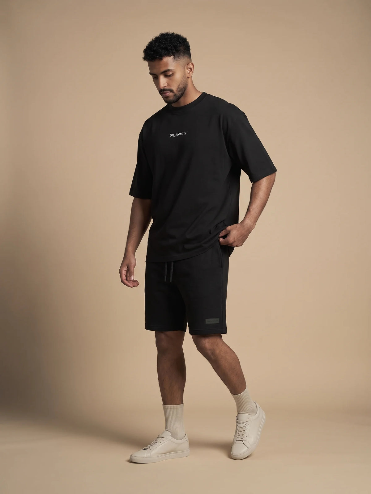 Black oversized t-shirt, Unidentity Soul Oversized Tee, full-length front view of a black-on-black look on man with Core shorts, streetwear #color_black