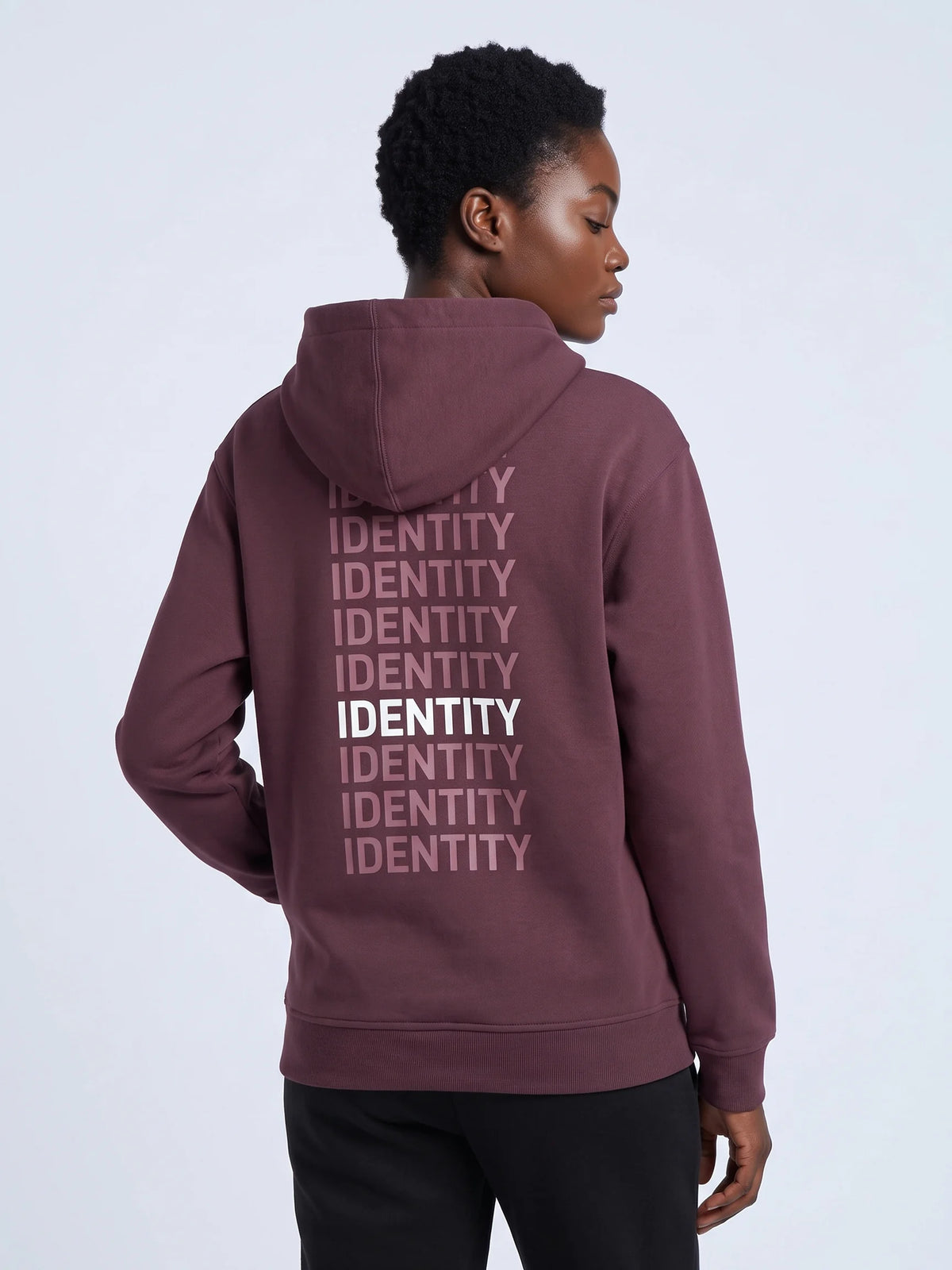 Plum regular fit hoodie, Unidentity Identity Regular Fit Hoodie, back close-up of the pink and white IDENTITY print worn by woman, streetwear #color_plum