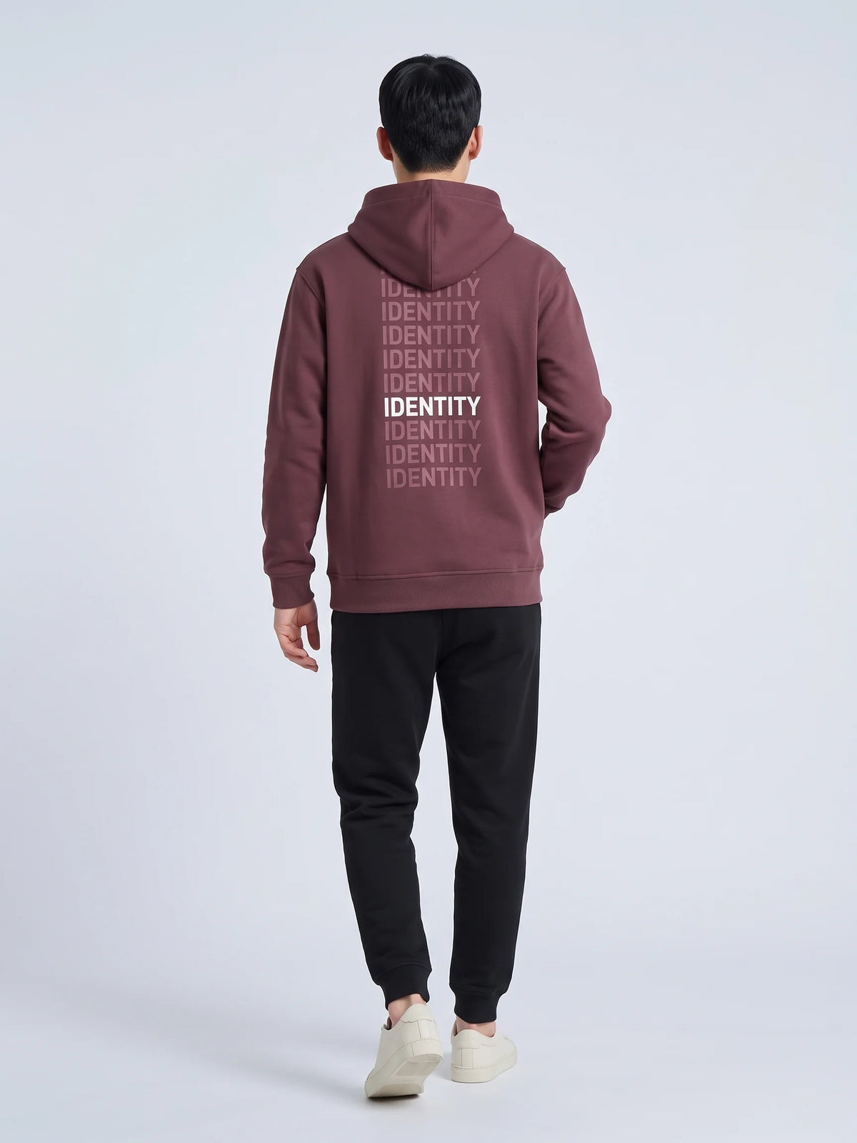 Plum regular fit hoodie in organic cotton, Unidentity Identity Hoodie, back view of the IDENTITY print worn by man walking, sustainable streetwear #color_plum