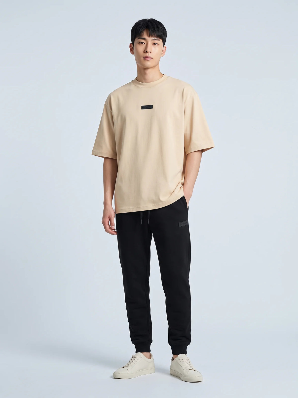 Beige heavyweight oversized t-shirt in organic cotton, Unidentity Identity Tee, full-length front view of the relaxed fit worn by man, 210gsm #color_beige
