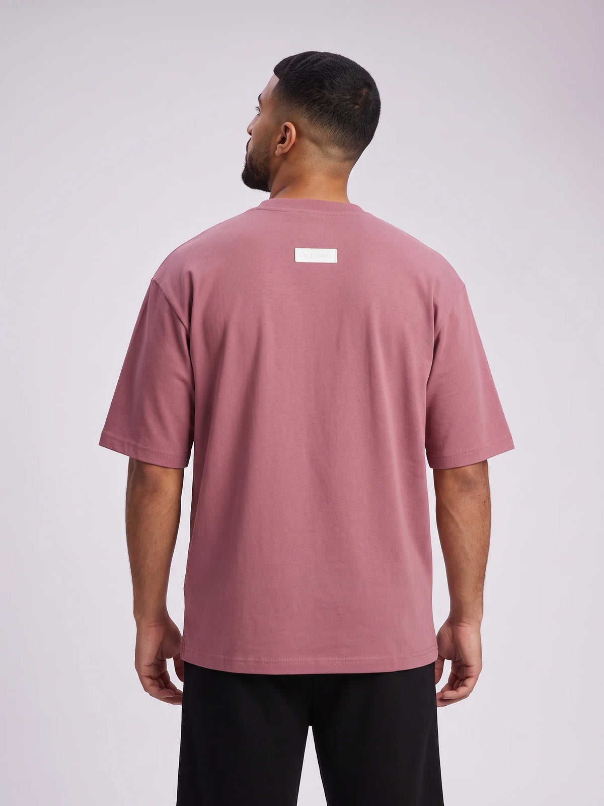 Plum heavyweight oversized t-shirt in organic cotton, Unidentity Foundation Tee, back close-up of the white 3D patch, 210gsm streetwear from Dubai #color_plum