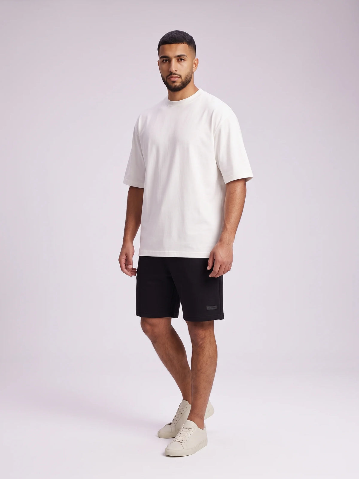 White organic cotton t-shirt, Unidentity Foundation Oversized Tee, full-length front view worn by man in a plain graphic-free design, 210gsm #color_white