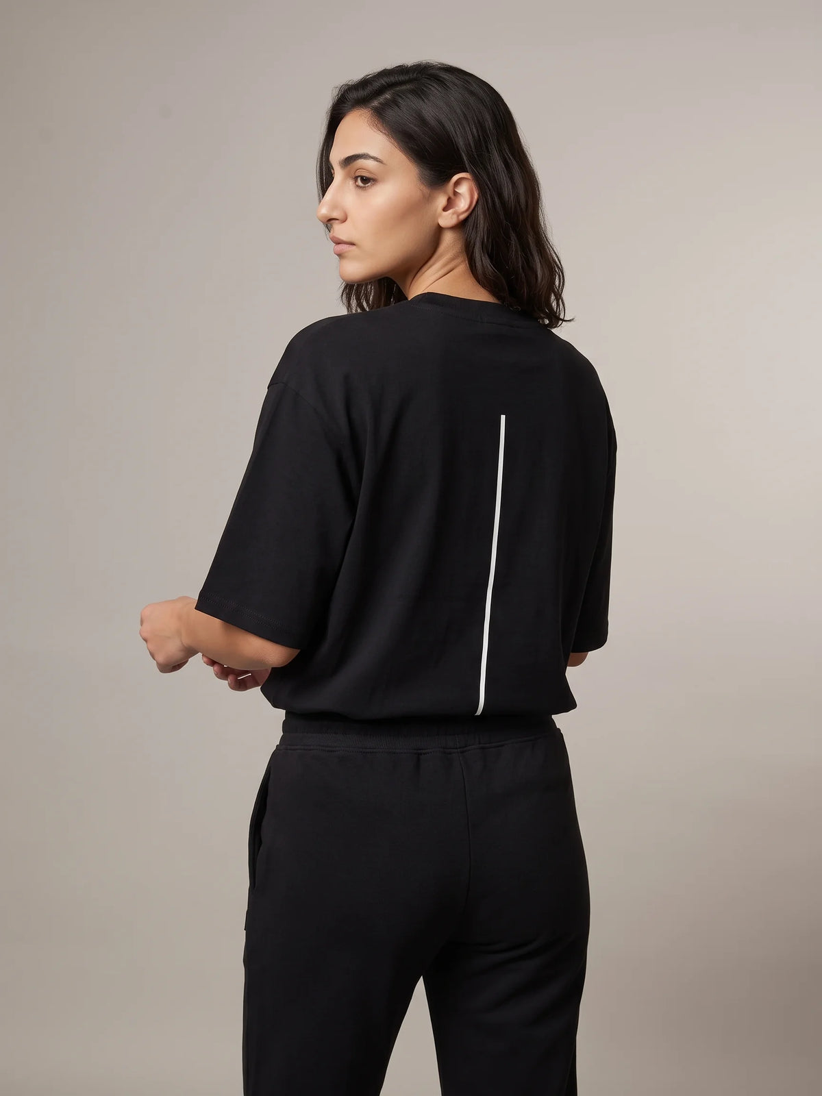 Black heavyweight oversized t-shirt in organic cotton, Unidentity Trace Tee, back view with white vertical line print, 210gsm streetwear from Dubai #color_black