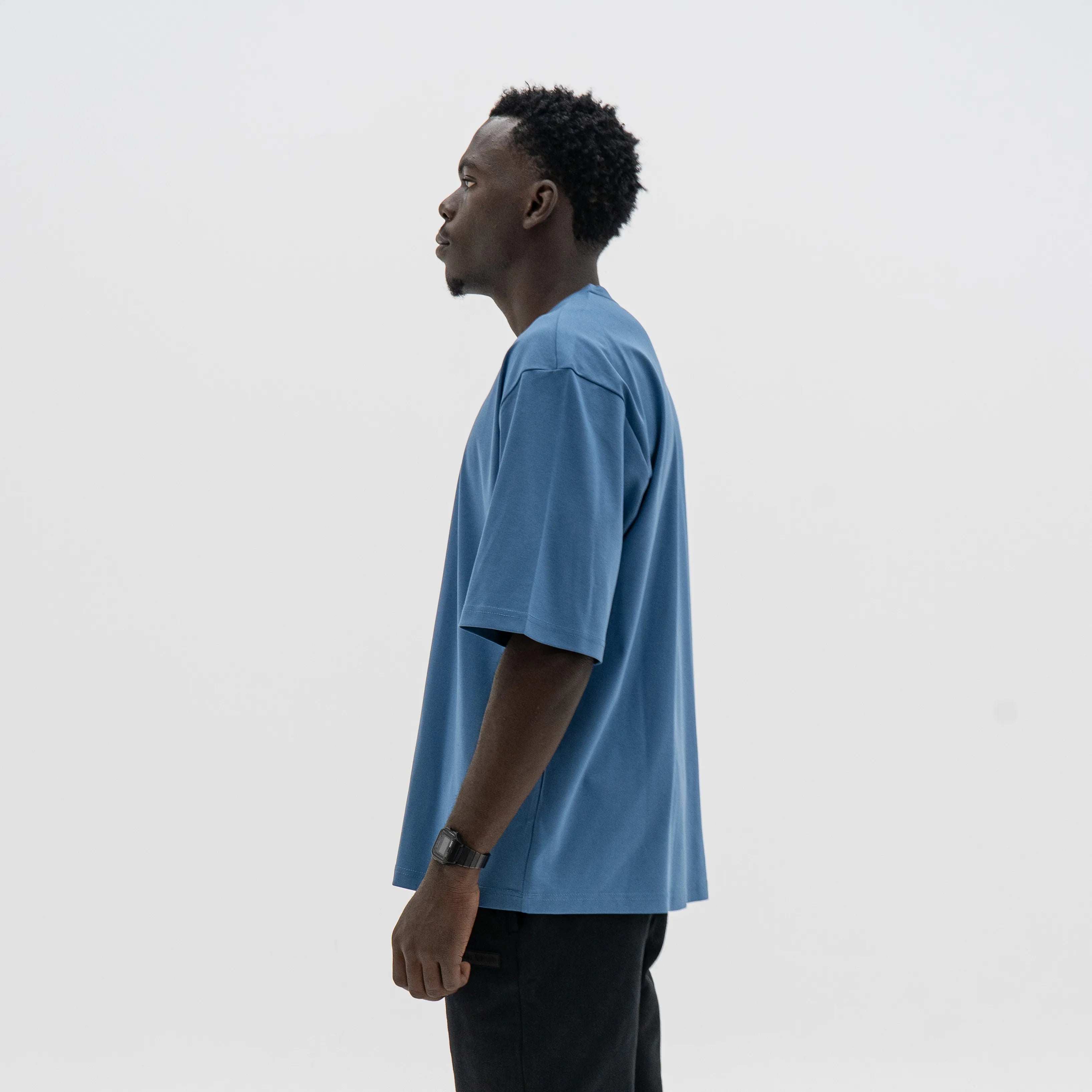 Man wearing a blue t-shirt against a plain background. #color_blue