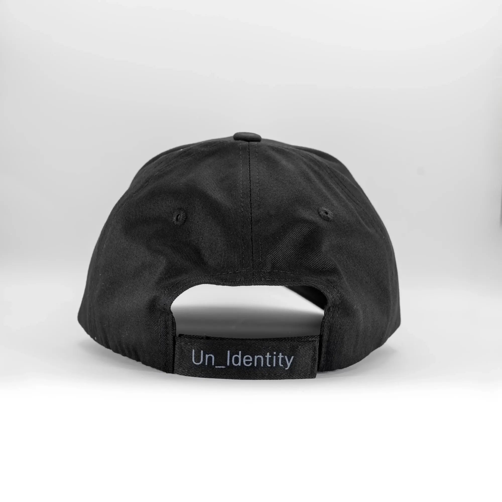 Black cap with Unidentity branding on the adjustable back strap