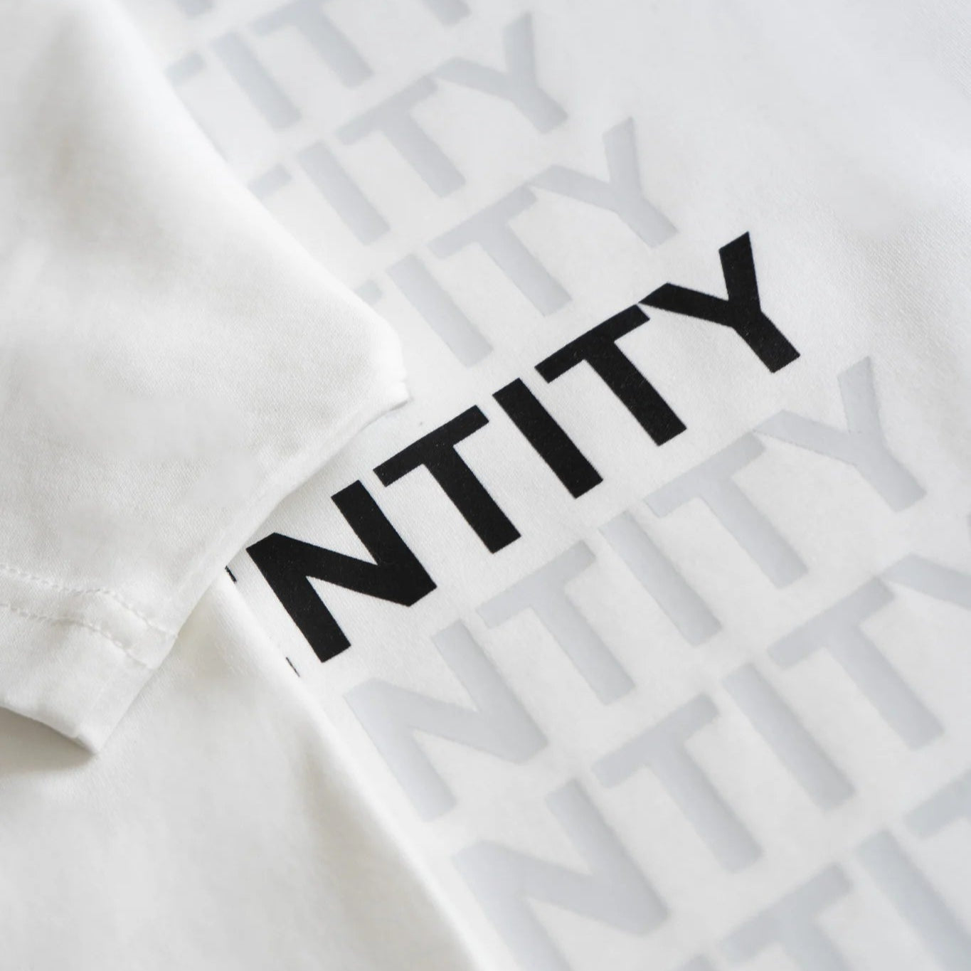 White t-shirt with black text on a white background. #color_white