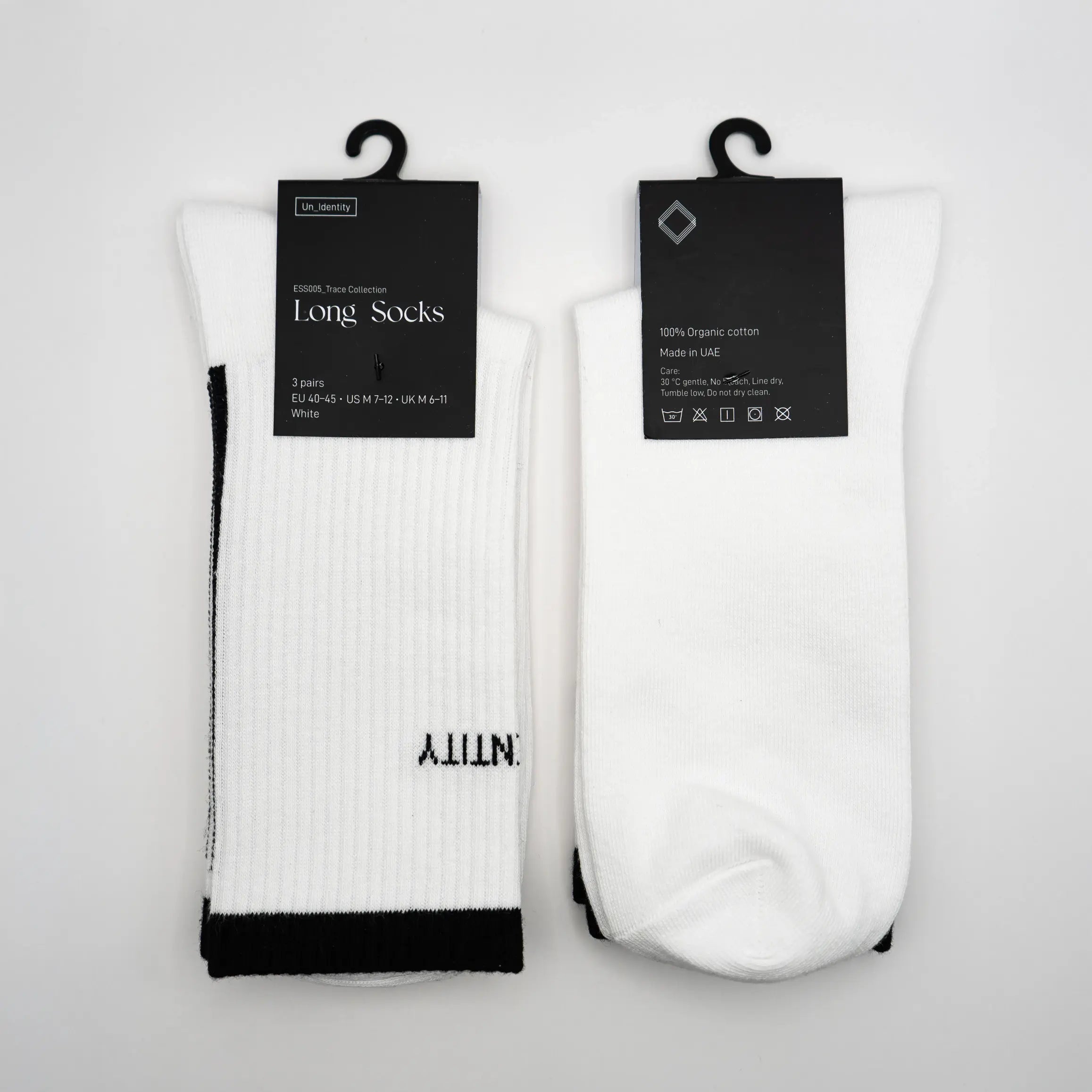 Two pairs of white Unidentity long socks with black accents