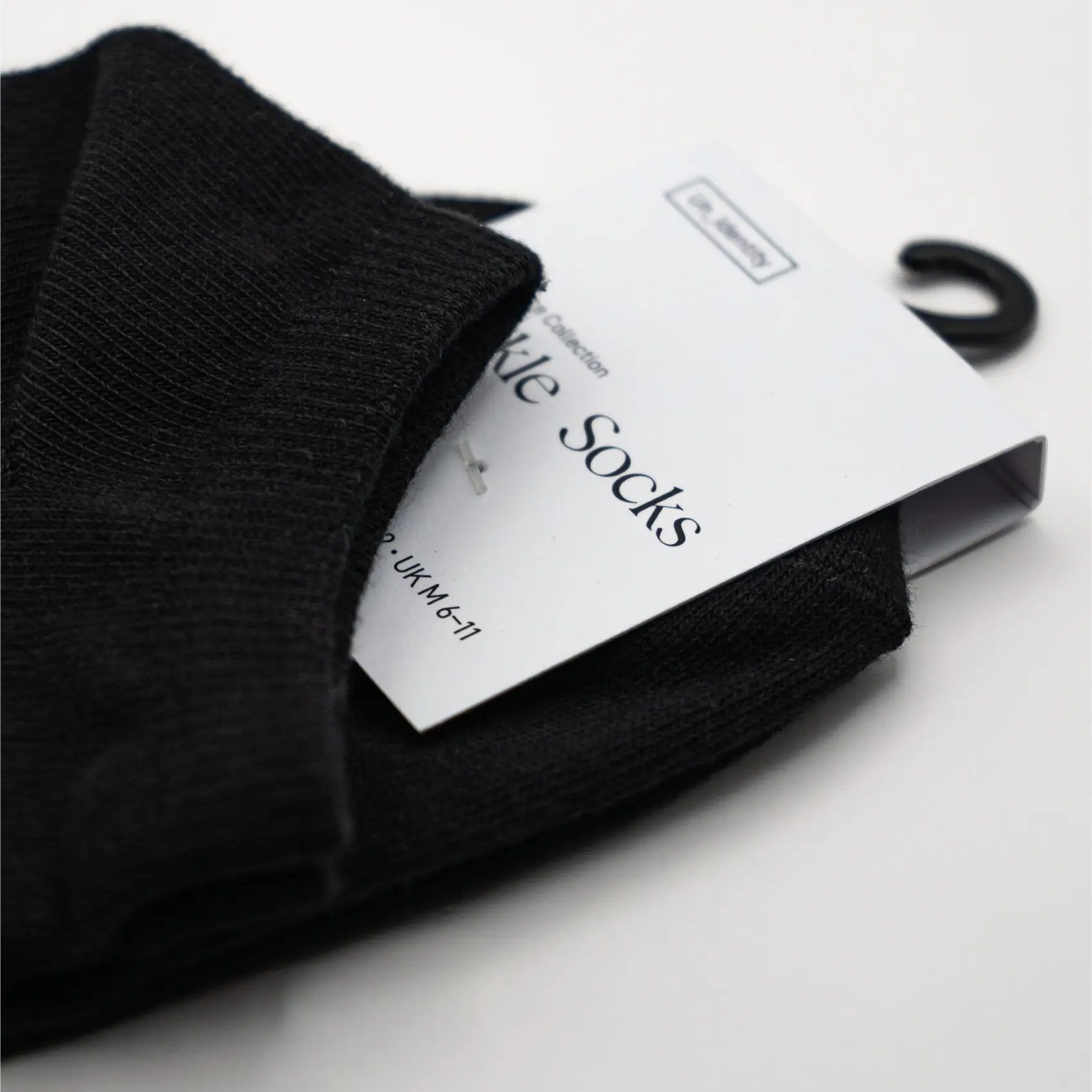 Black Unidentity sock with a white label. #color_black