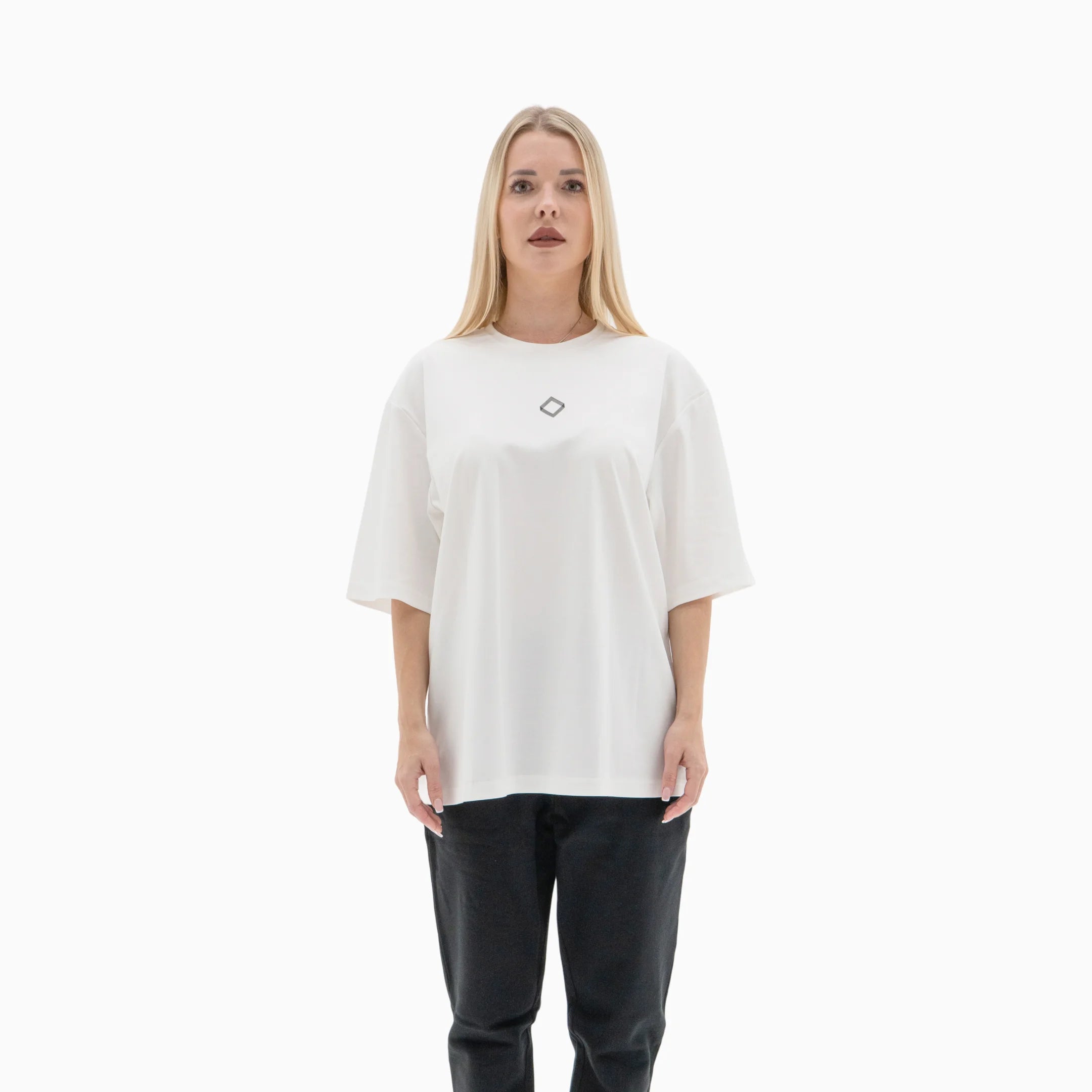Person wearing a white t-shirt with a black logo on the chest against a plain background. #color_white