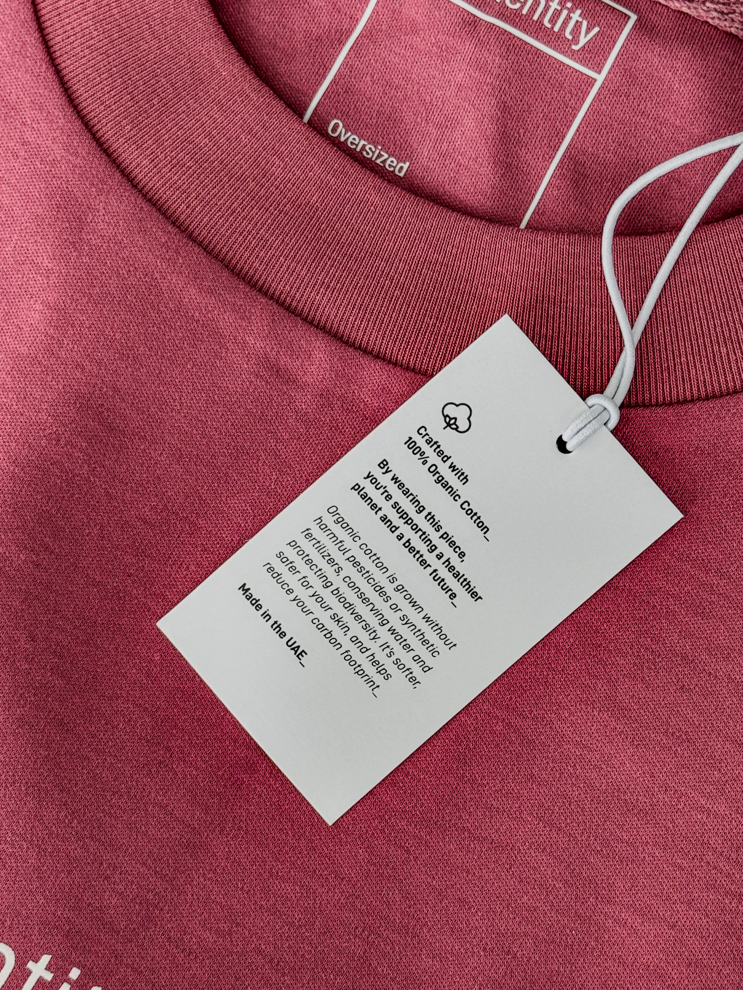 Maroon garment with a white tag displaying text