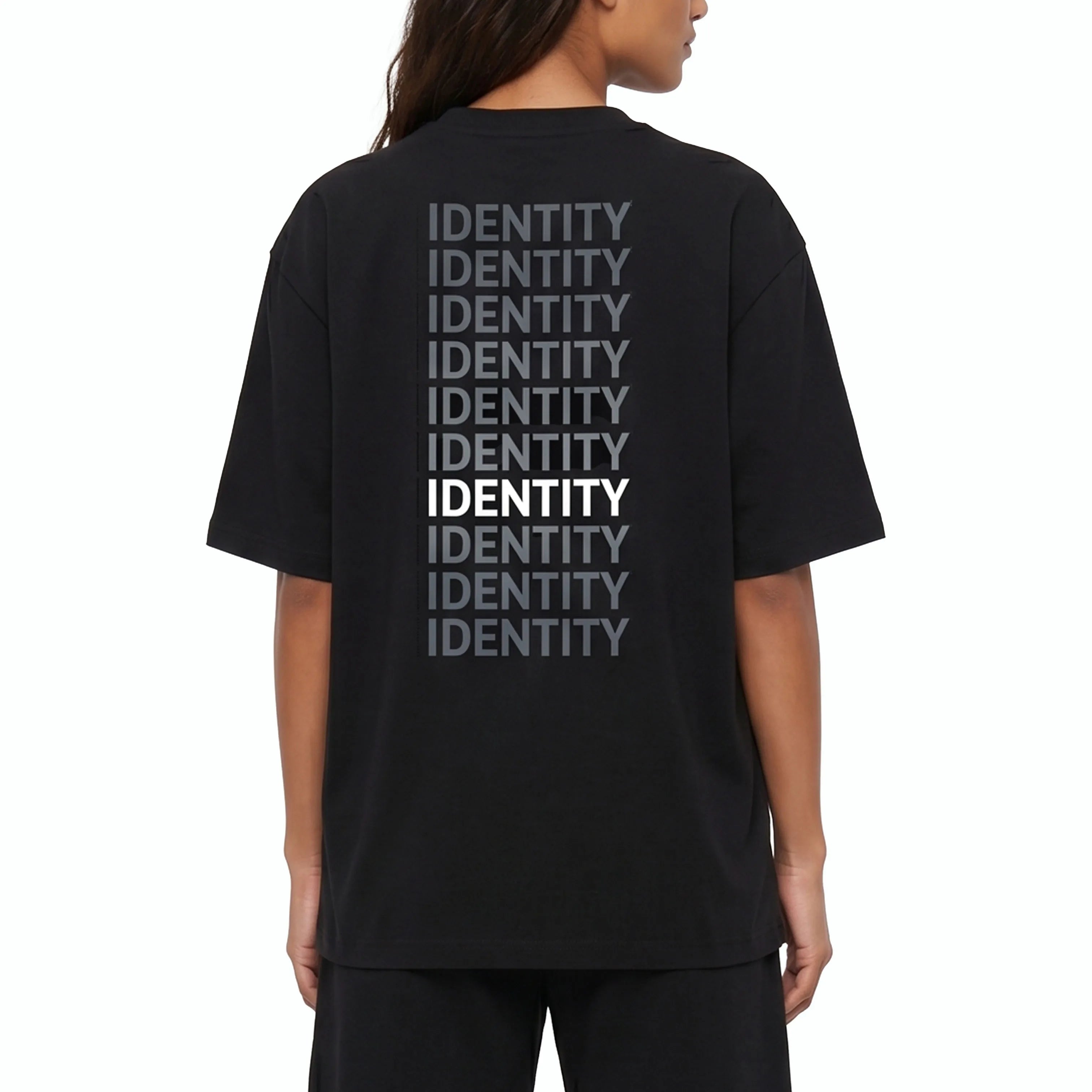 Person wearing black Unidentity T-shirt with identity printed on the back. #color_black