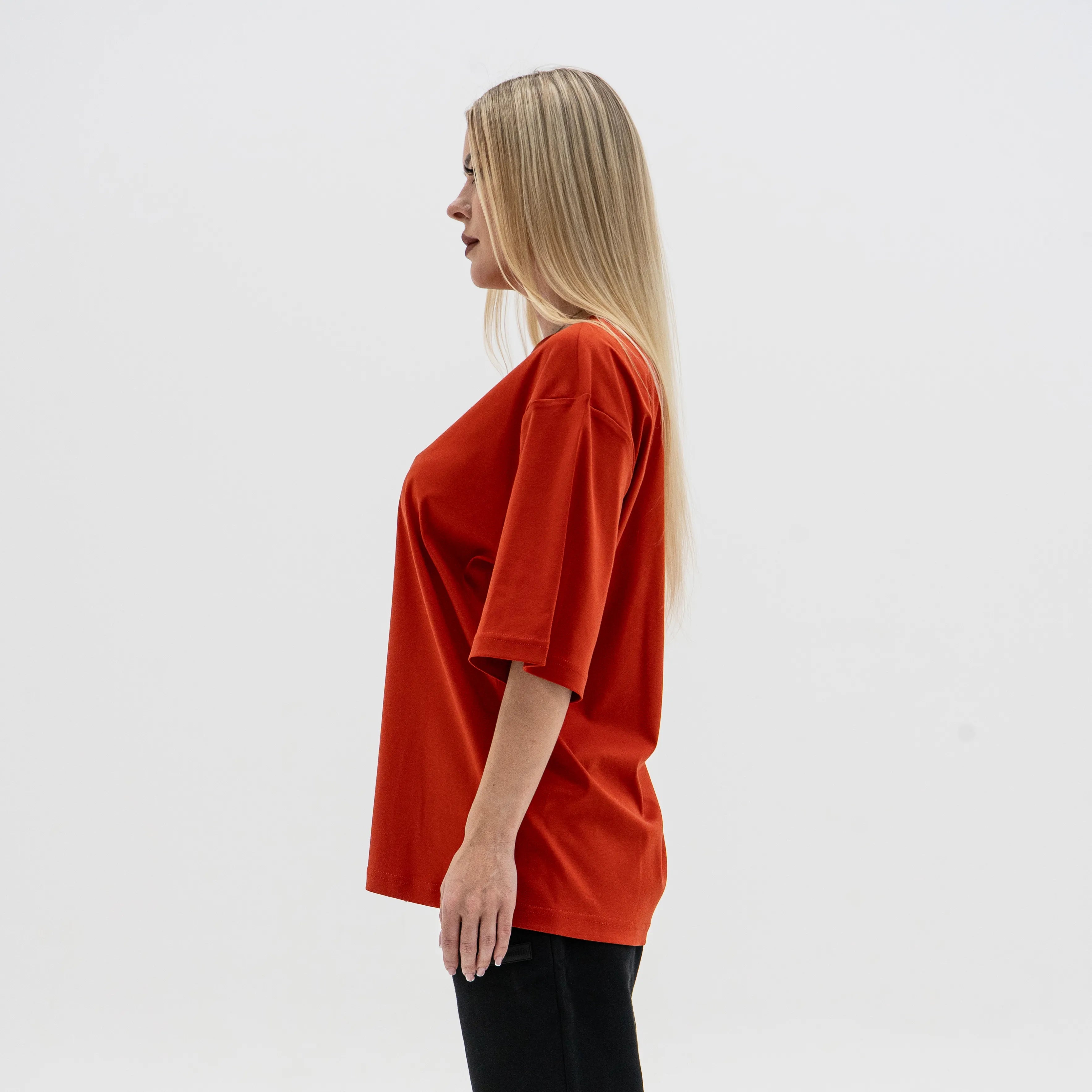 Woman wearing a red oversized shirt on a white background. #color_red