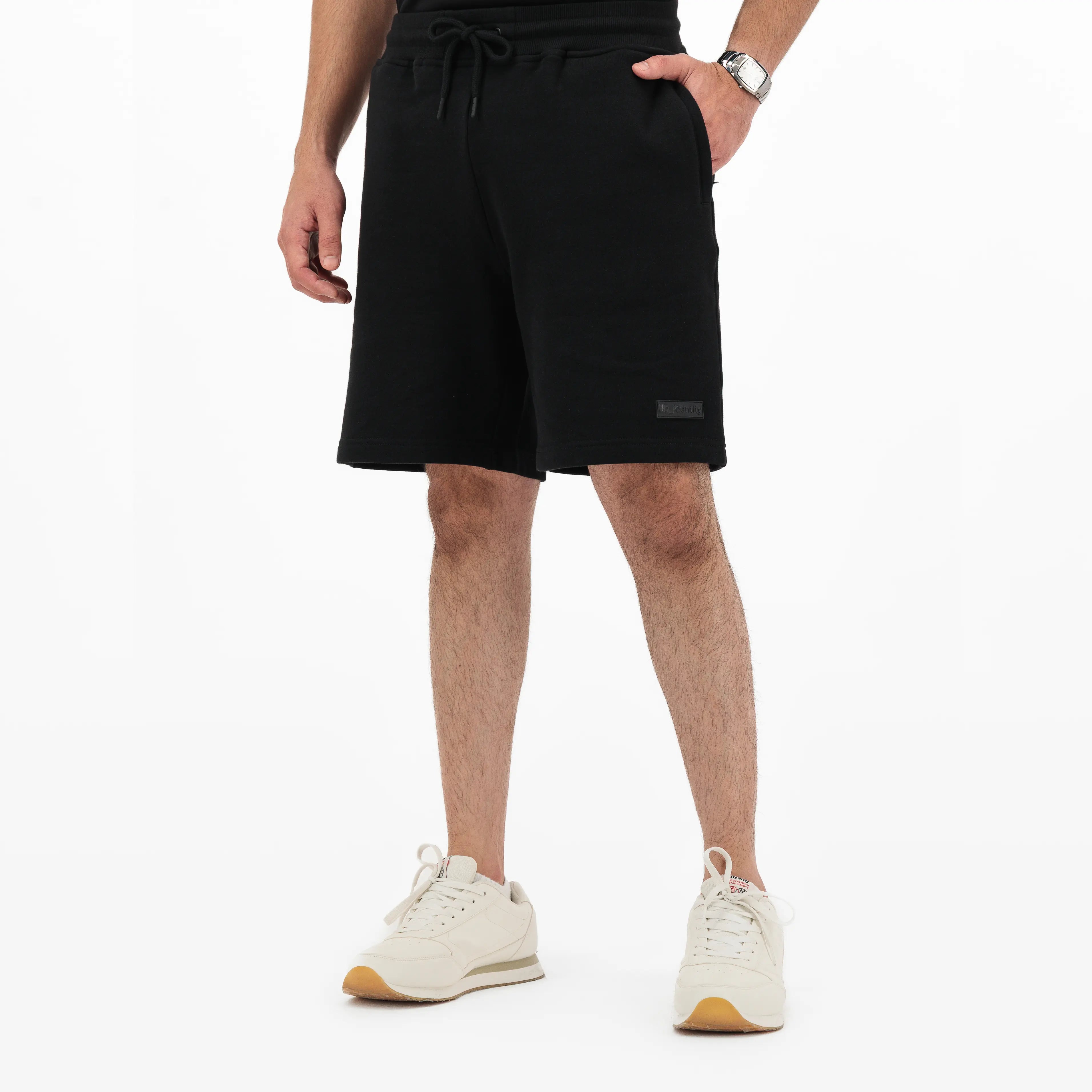 Person wearing black shorts with drawstring and tonal Unidentity logo