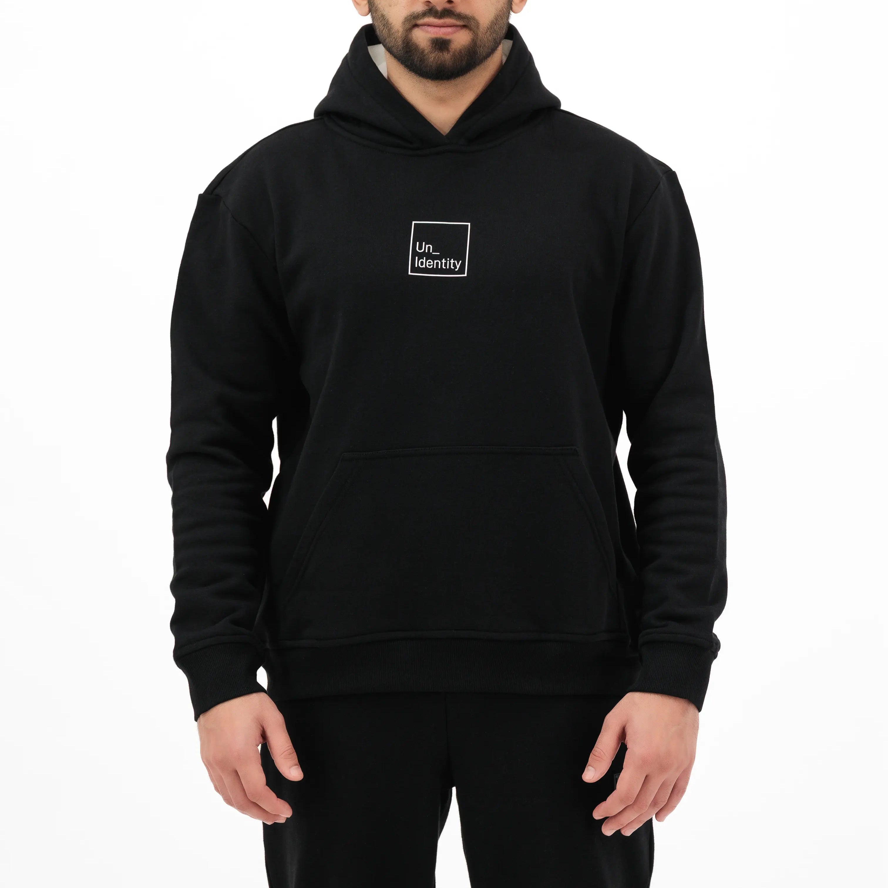Man wearing black hoodie with white Unidentity logo on the chest. #color_black