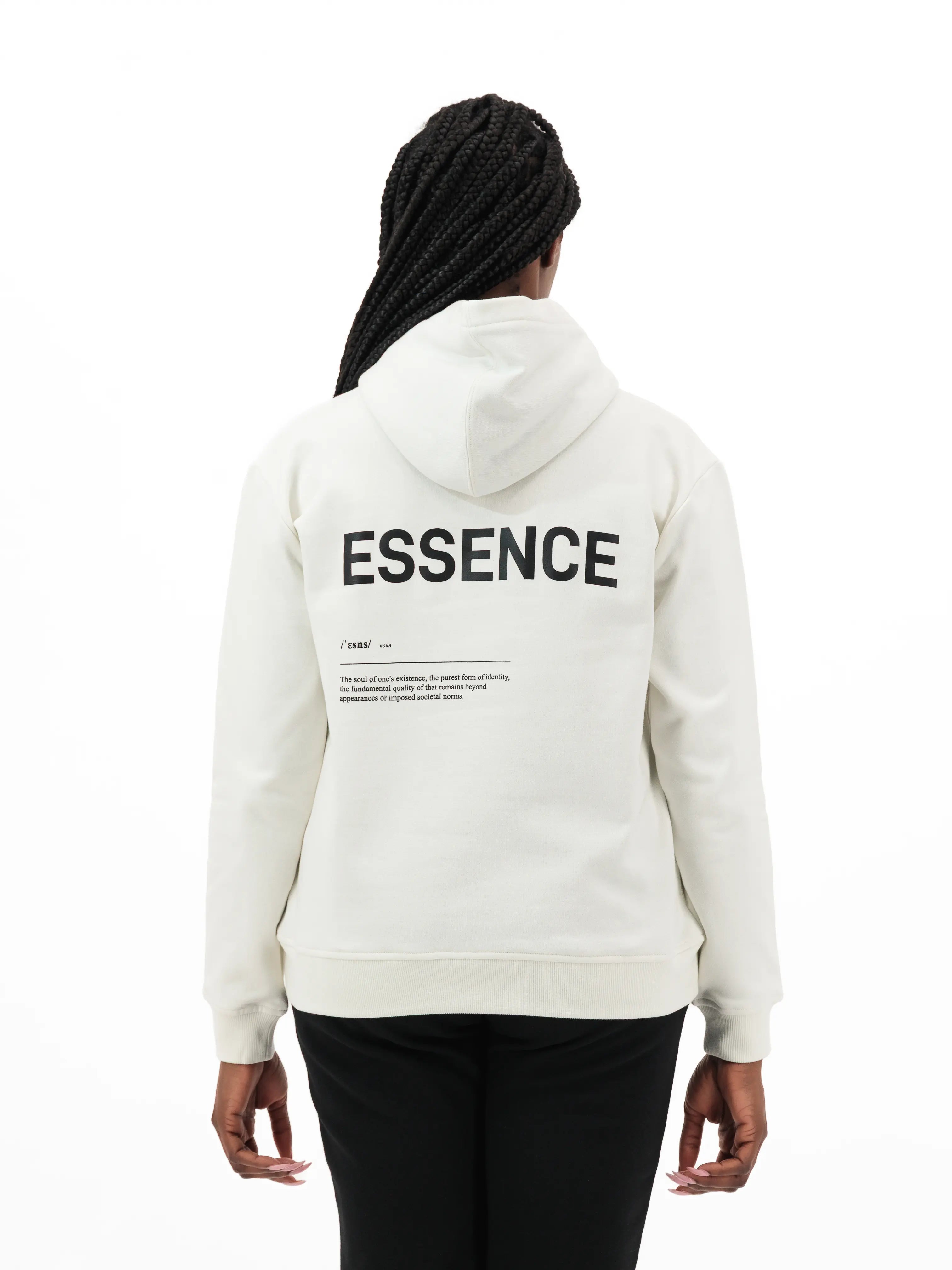 Person wearing white hoodie with ESSENCE text on the back. #color_white