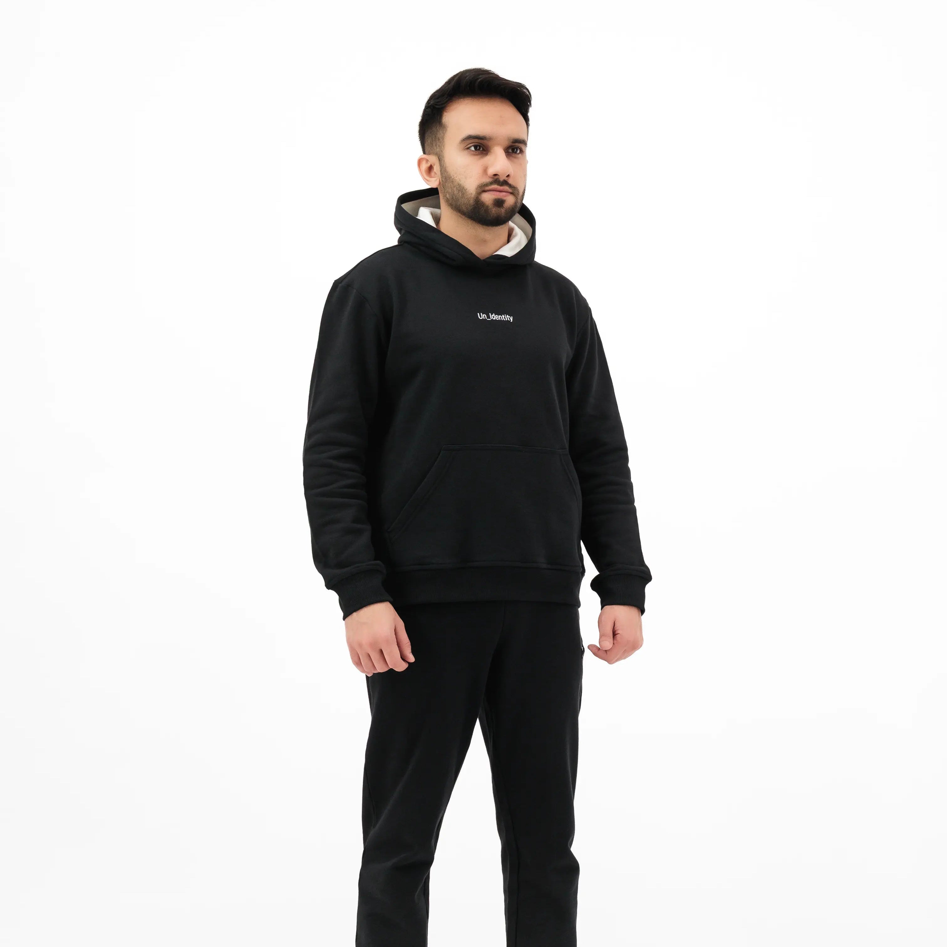 Model wearing black Unidentity hoodie and pants. #color_black