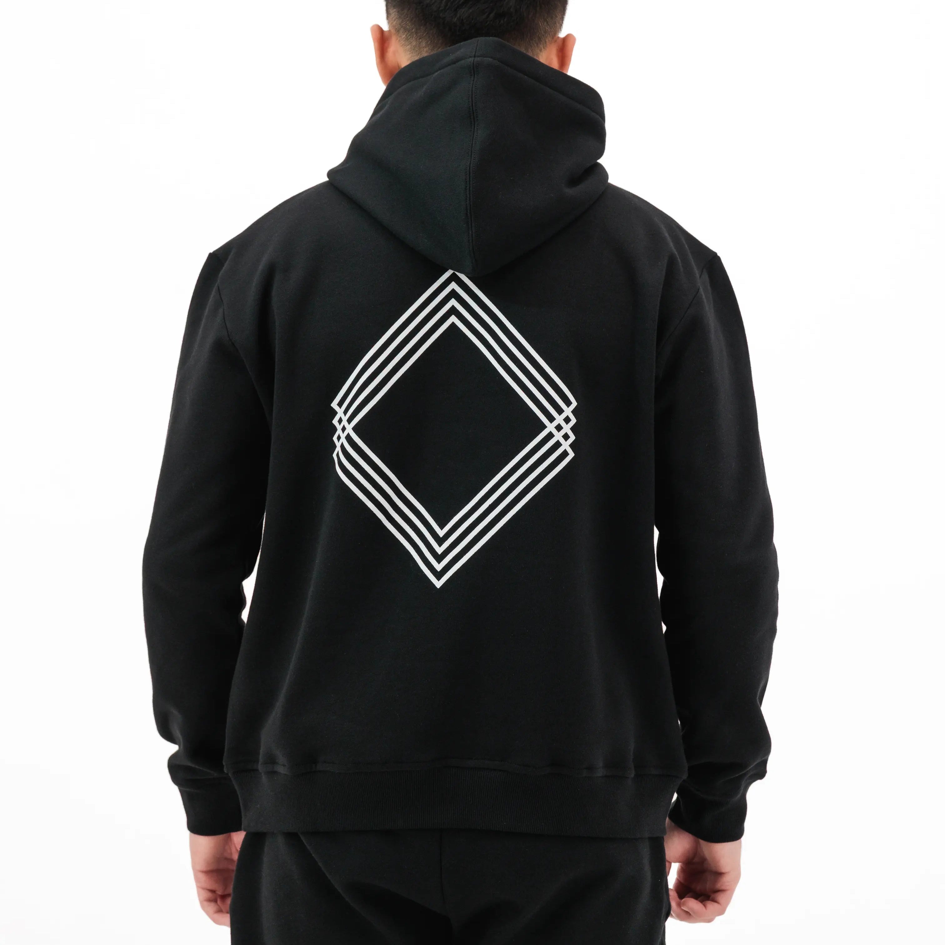 Man wearing black hoodie with white Gem design on the back. #color_black
