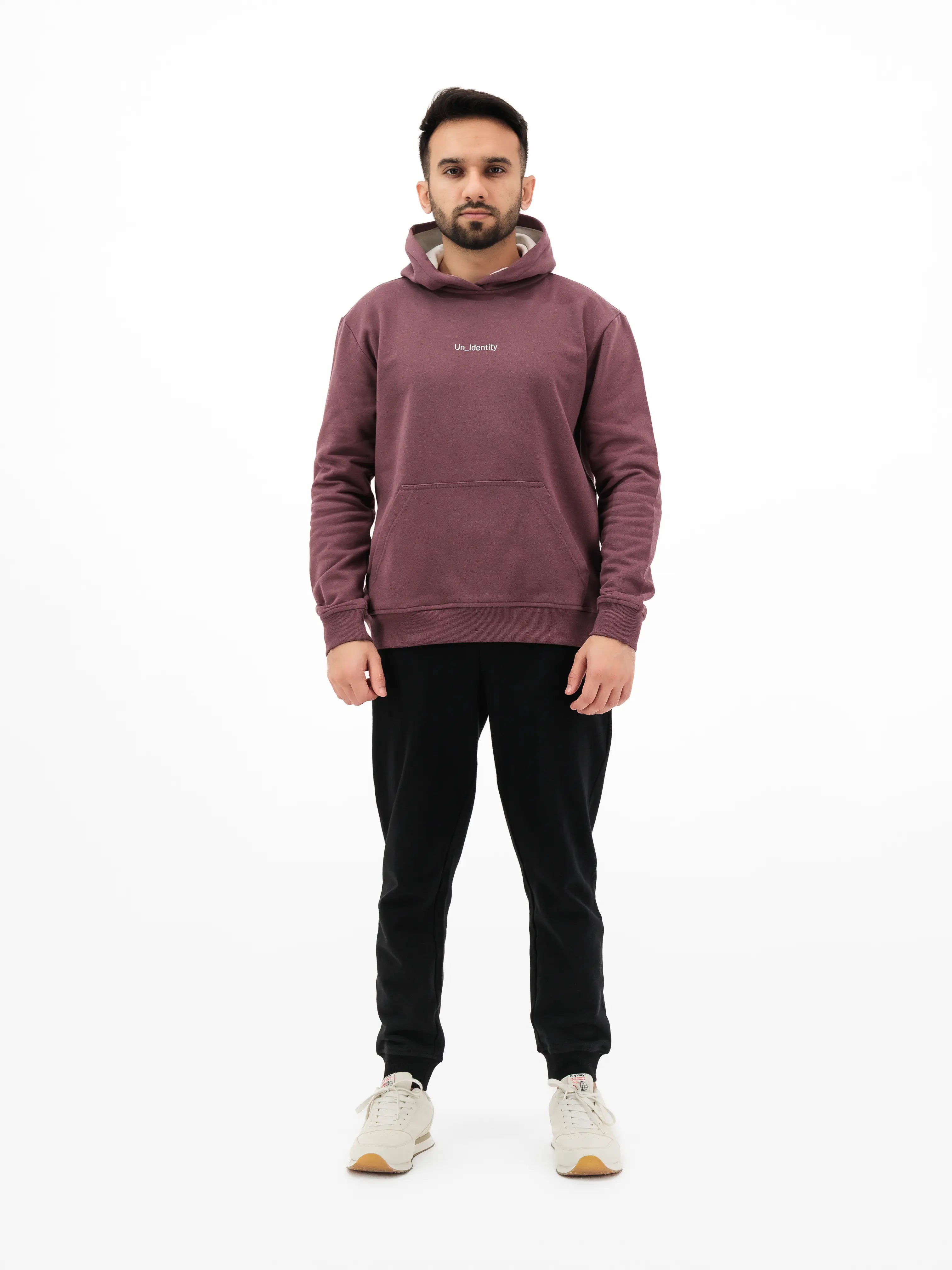 Man wearing maroon hoodie and black pants. #color_plum