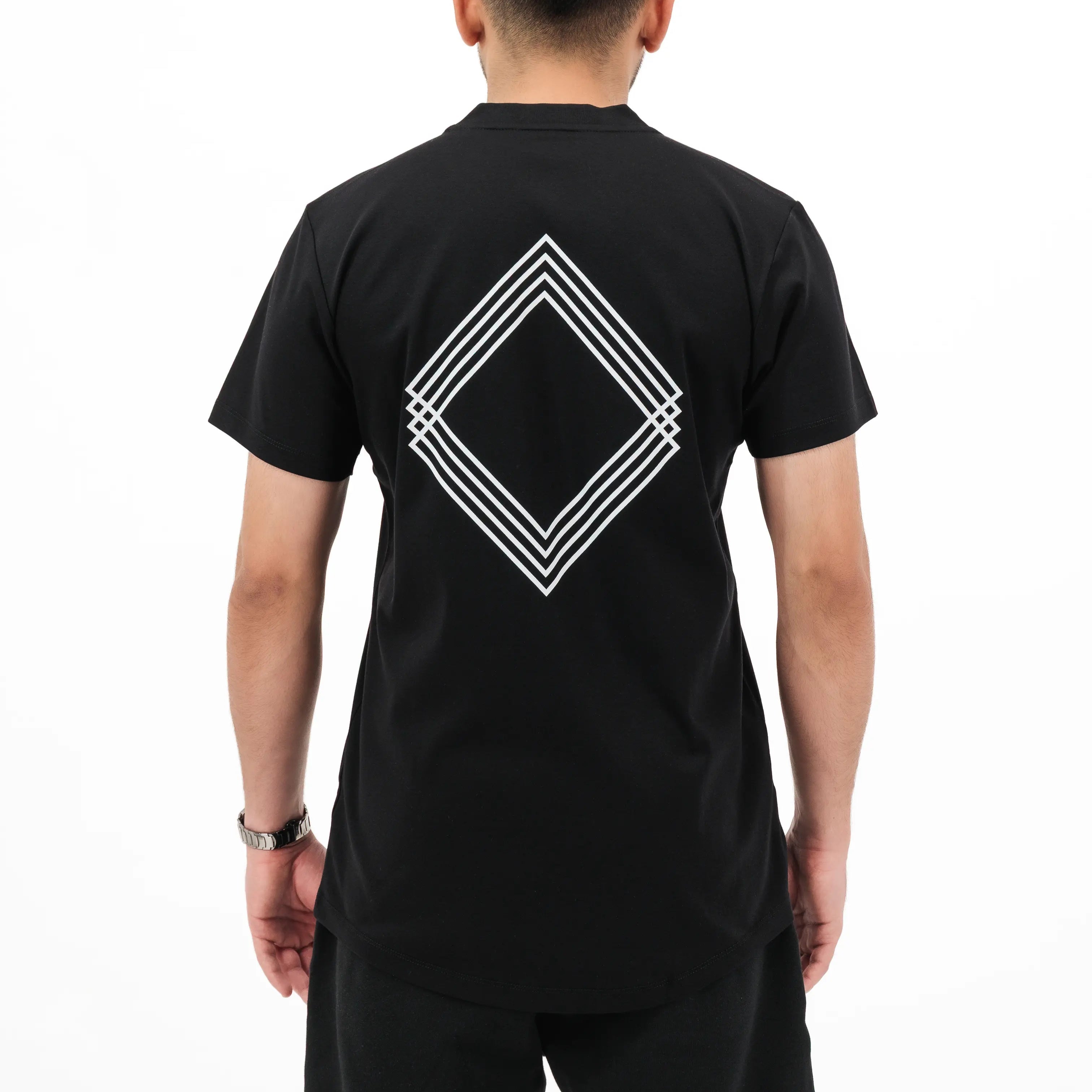 Model wearing black T-shirt with white Gem Unidentity logo on the back. #color_black