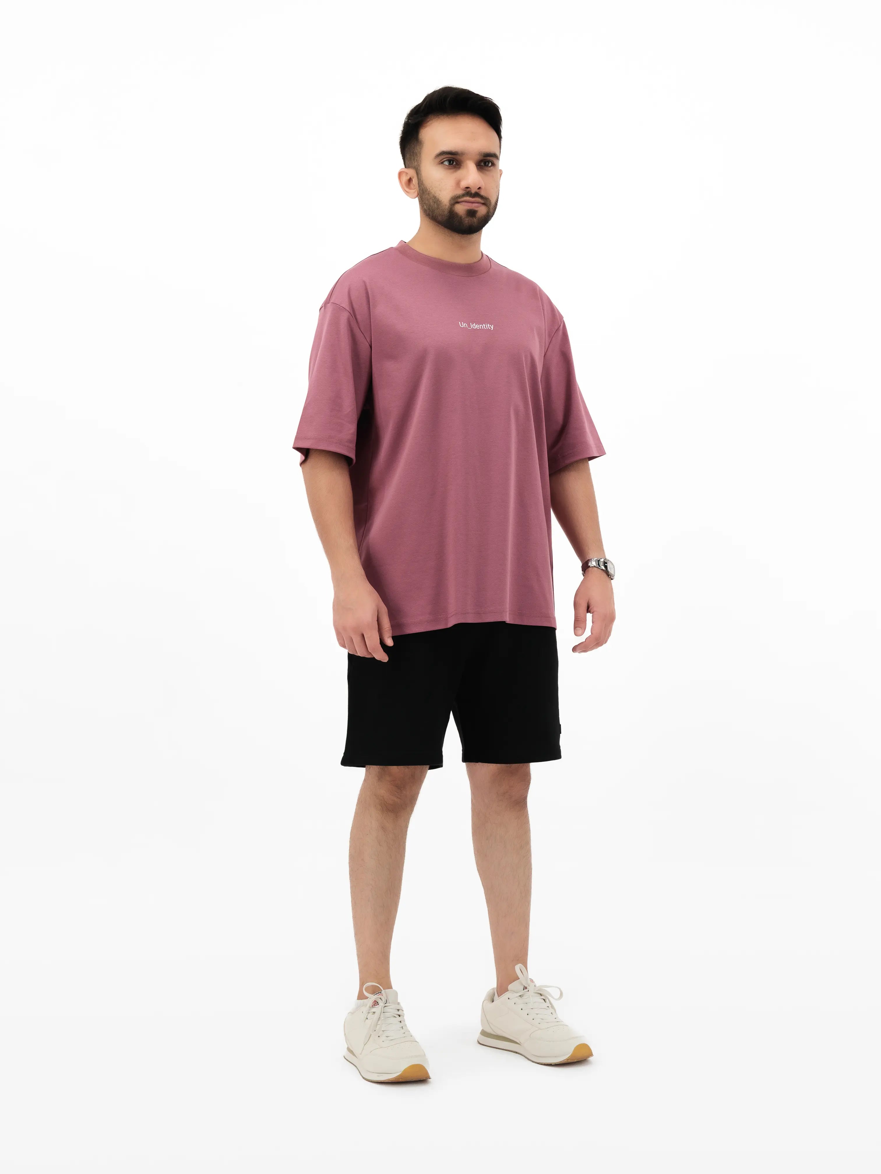 Model wearing Unidentity plum T-shirt and black shorts