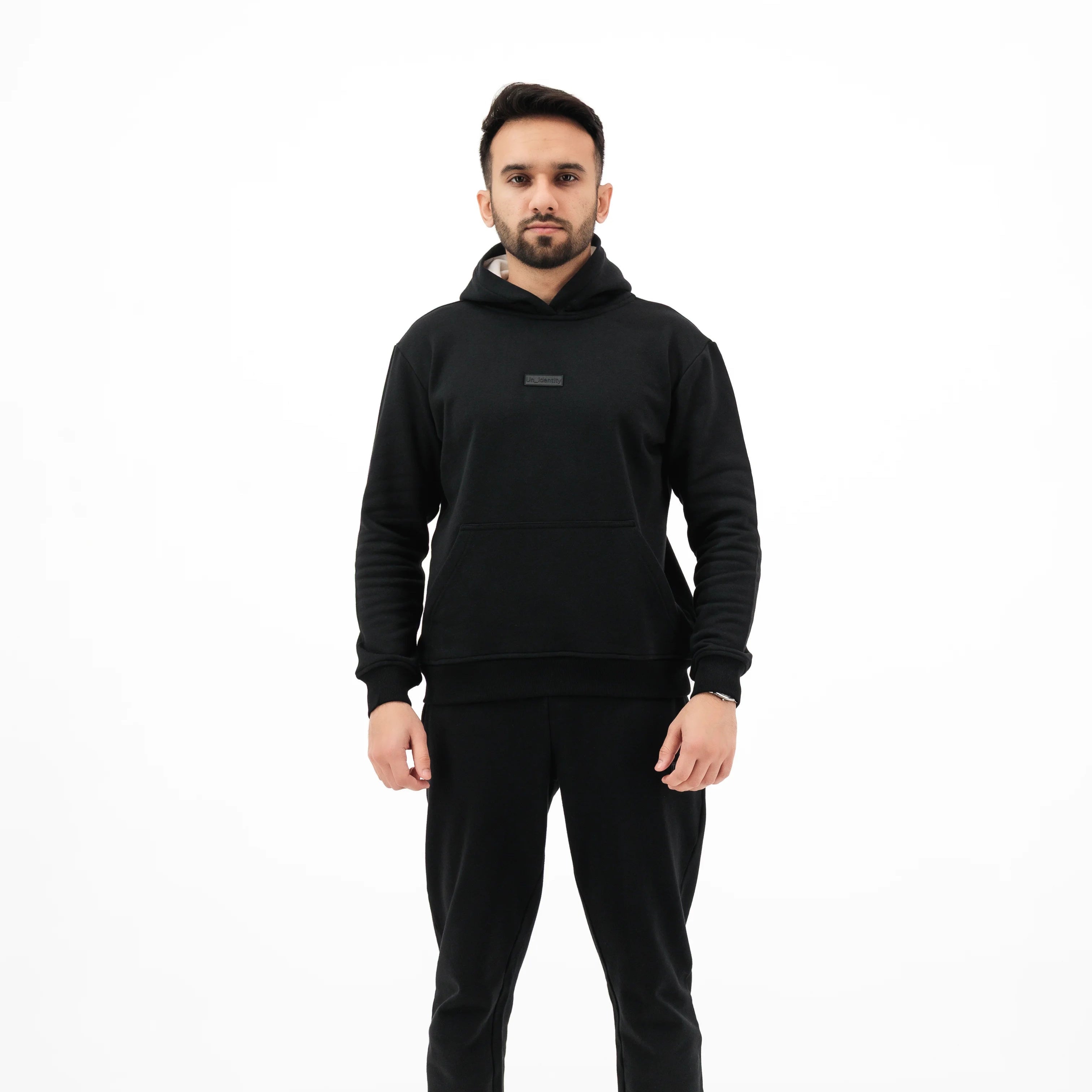Man wearing black Unidentity hoodie and pants. #color_black