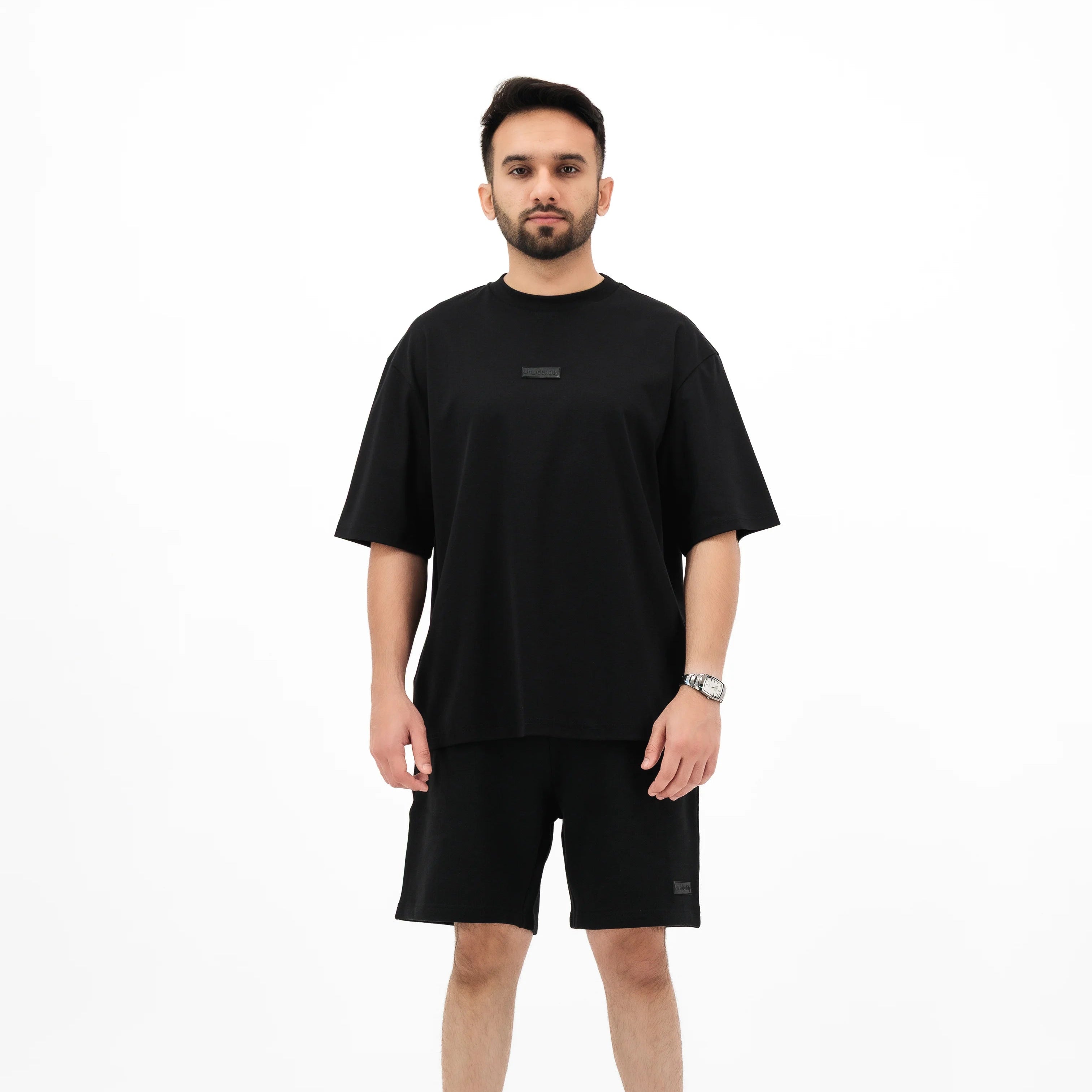 Man wearing black Unidentity t-shirt and shorts set. #color_black