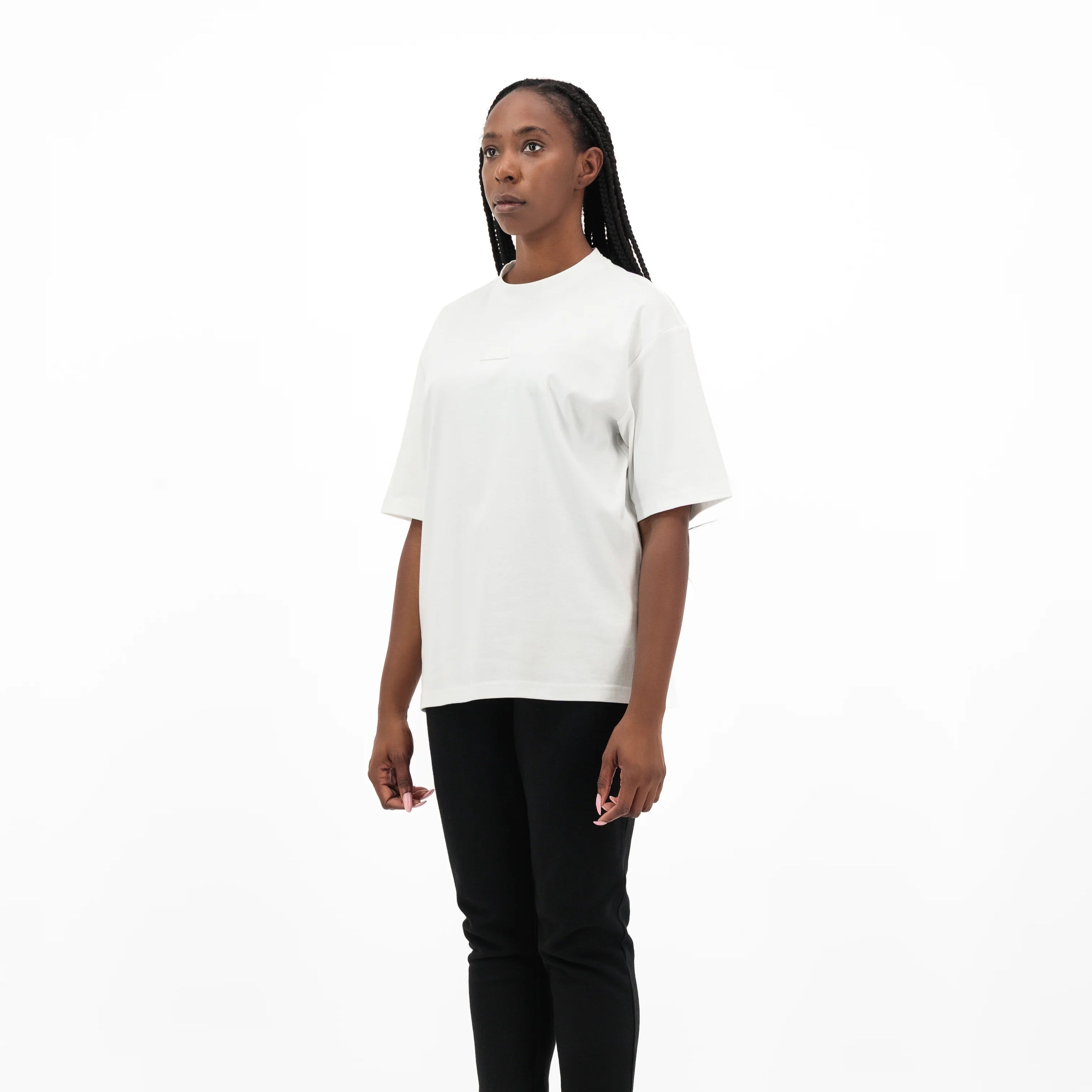 Woman wearing white t-shirt and black pants. #color_white