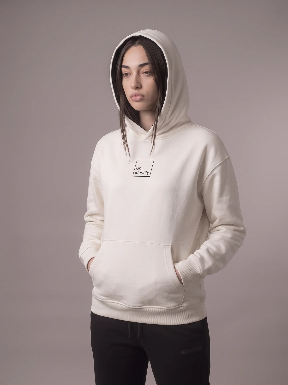 White heavyweight hoodie in organic cotton, Unidentity Core Hoodie, front view on woman with hood up and boxed logo, 390gsm Dubai streetwear #color_white