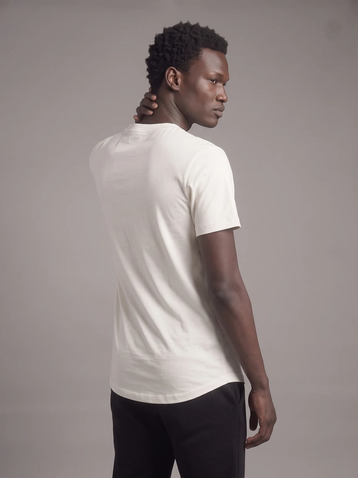 White long fit t-shirt, Unidentity Core Tee, back view on man showing the clean plain back and long curved hem, streetwear #color_white