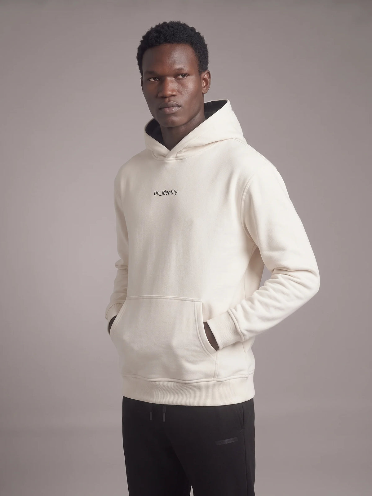 White organic cotton hoodie, Unidentity Gem Hoodie, front three-quarter view on man with Un_Identity chest wordmark, sustainable fashion #color_white