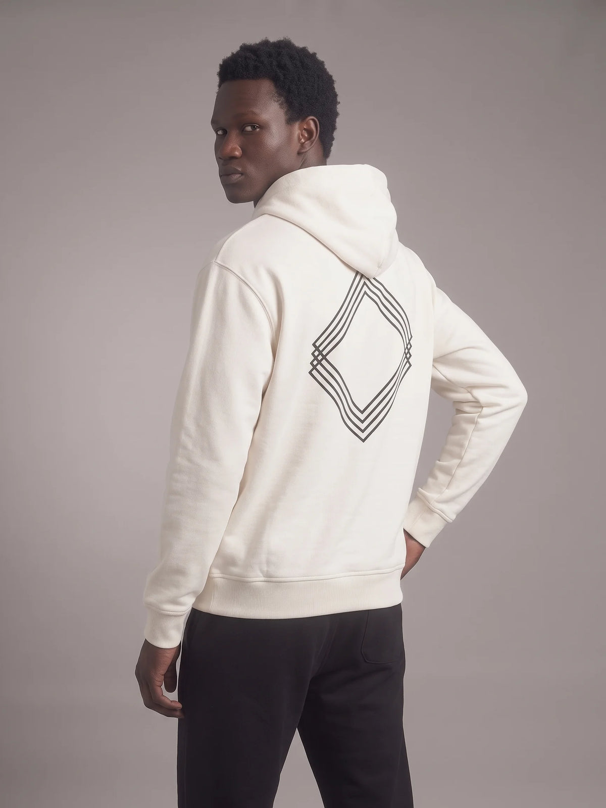 White heavyweight hoodie in organic cotton, Unidentity Gem Hoodie, back view on man with black layered diamond logo, 390gsm UAE streetwear #color_white