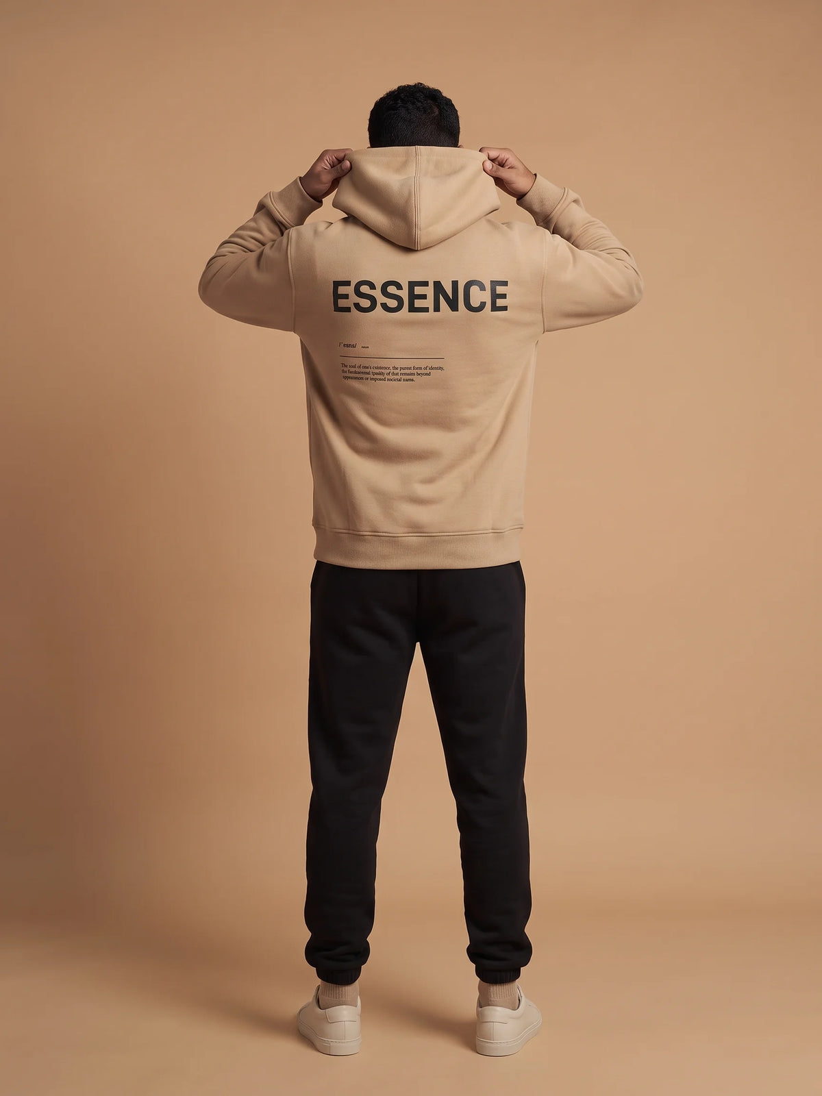 Beige regular fit hoodie, Unidentity Soul Hoodie, full-length back view of the ESSENCE definition print worn by man pulling up the hood, 390gsm #color_beige