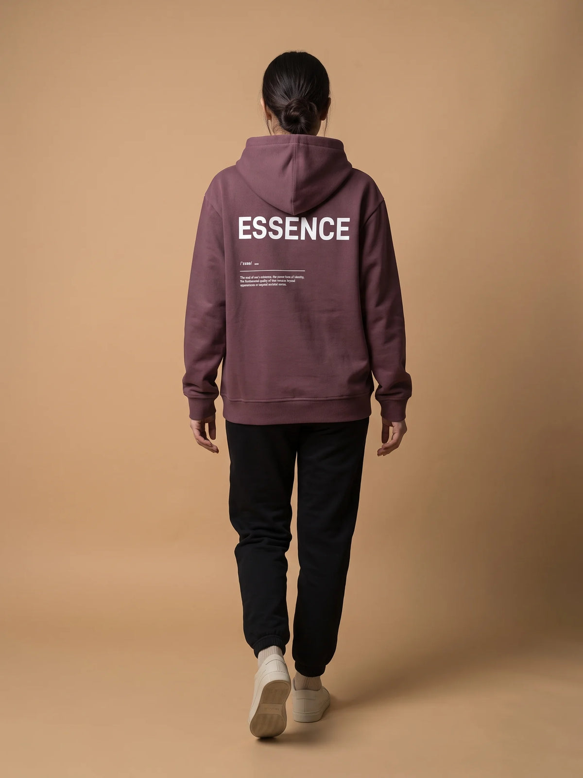 Plum regular fit hoodie, Unidentity Soul Hoodie, full-length back view of the ESSENCE print worn by woman with black Core joggers, organic cotton #color_plum