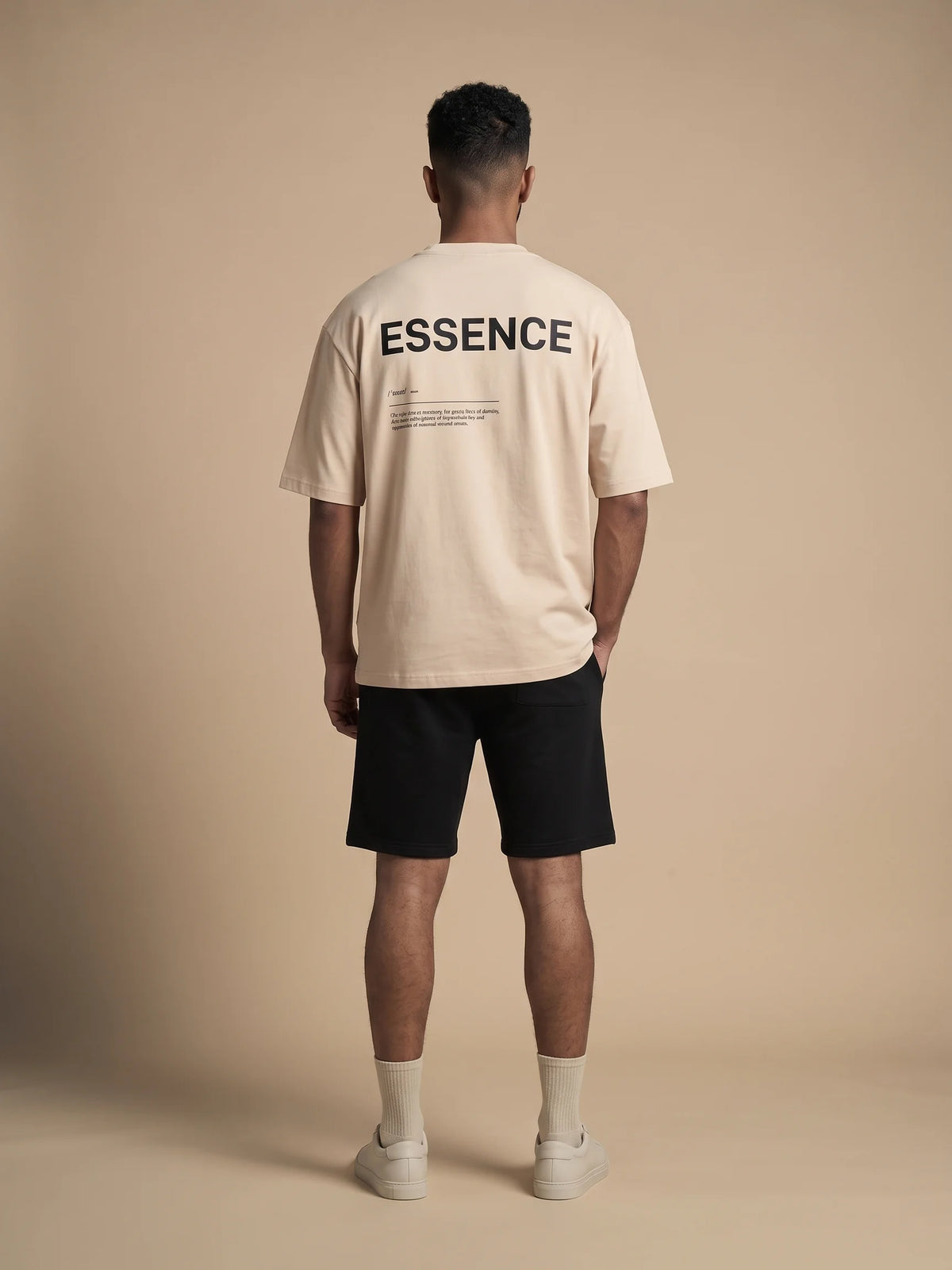 Beige oversized t-shirt in organic cotton, Unidentity Soul Tee, full-length back view of the ESSENCE print worn by man, streetwear #color_beige