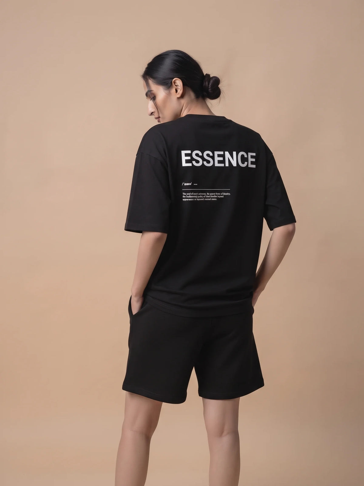 Black heavyweight oversized t-shirt, Unidentity Soul Tee, back side view of the ESSENCE print worn by woman with black Core shorts, organic cotton #color_black