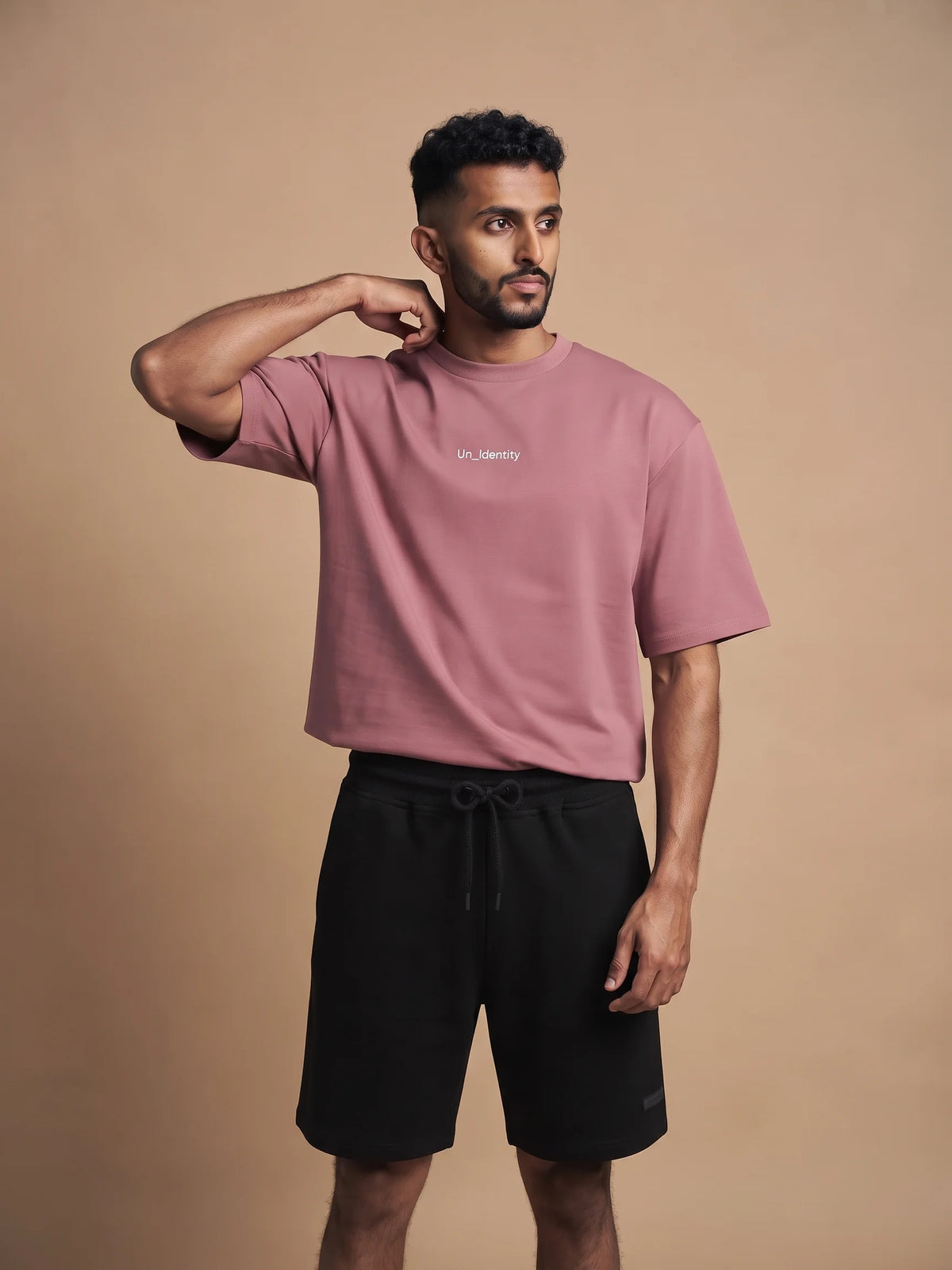 Plum organic cotton t-shirt, Unidentity Soul Oversized Tee, front view of the chest logo worn by man with black Core shorts, 210gsm #color_plum
