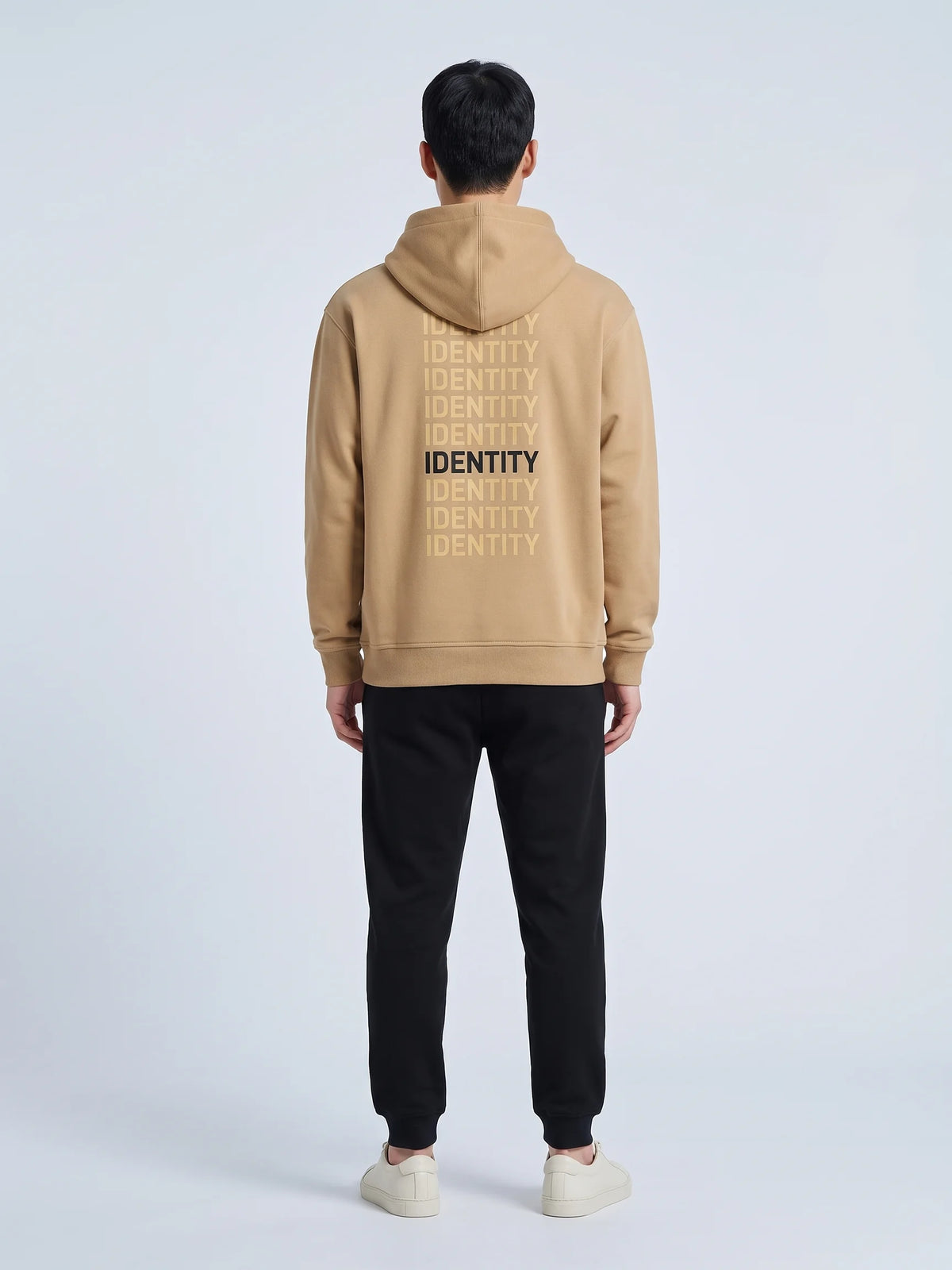 Beige heavyweight hoodie in organic cotton, Unidentity Identity Hoodie, full-length back view worn by man, 390gsm streetwear brand in Dubai #color_beige