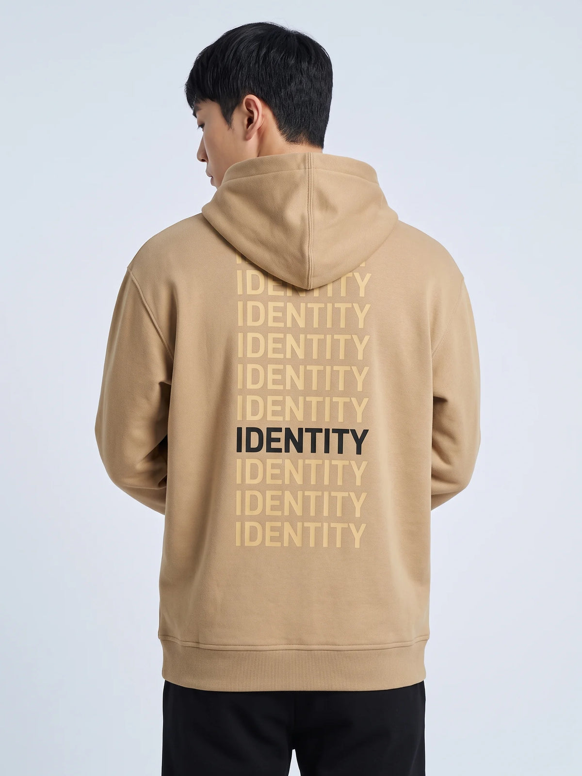 Beige regular fit hoodie, Unidentity Identity Hoodie, back close-up of the tonal IDENTITY print with one black line worn by man, streetwear #color_beige