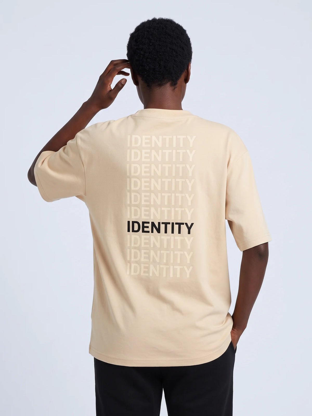 Beige heavyweight oversized t-shirt in organic cotton, Unidentity Identity Tee, back close-up of the IDENTITY print, 210gsm UAE streetwear #color_beige