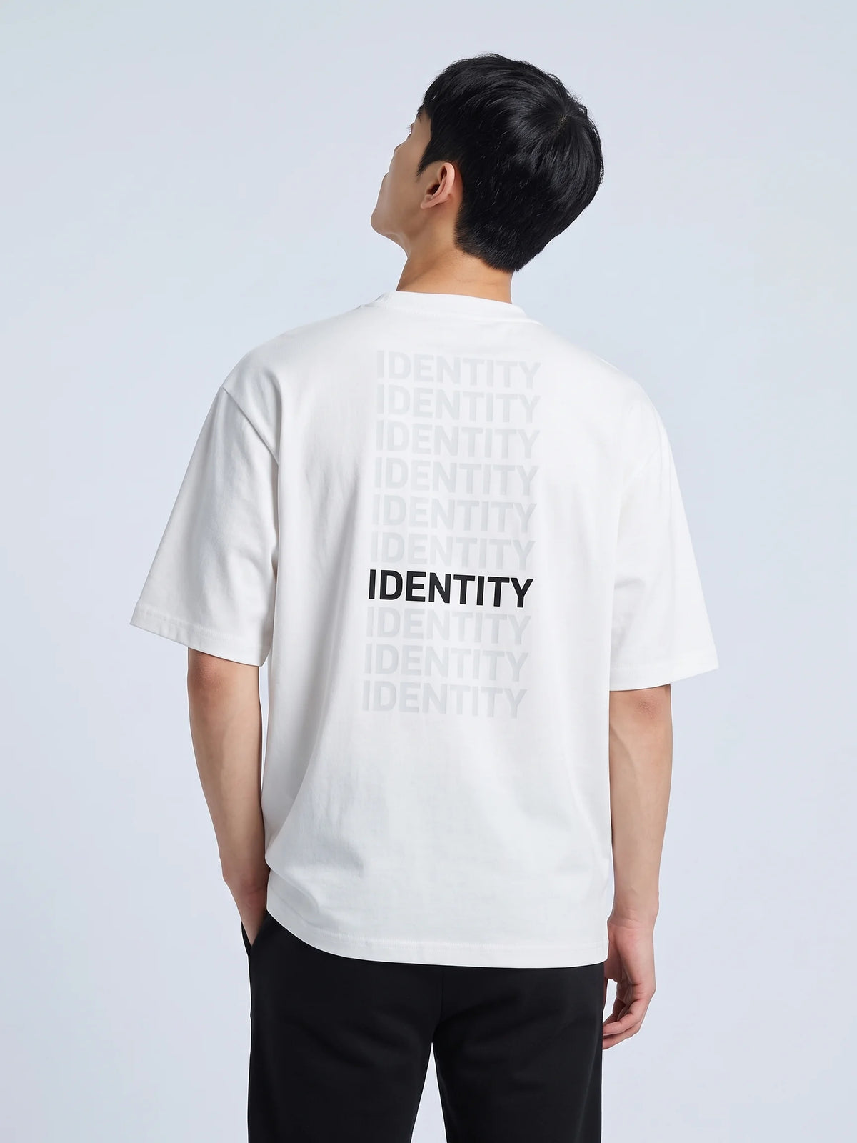 White heavyweight oversized t-shirt in organic cotton, Unidentity Identity Tee, back close-up of the gray and black IDENTITY print, from Dubai #color_white