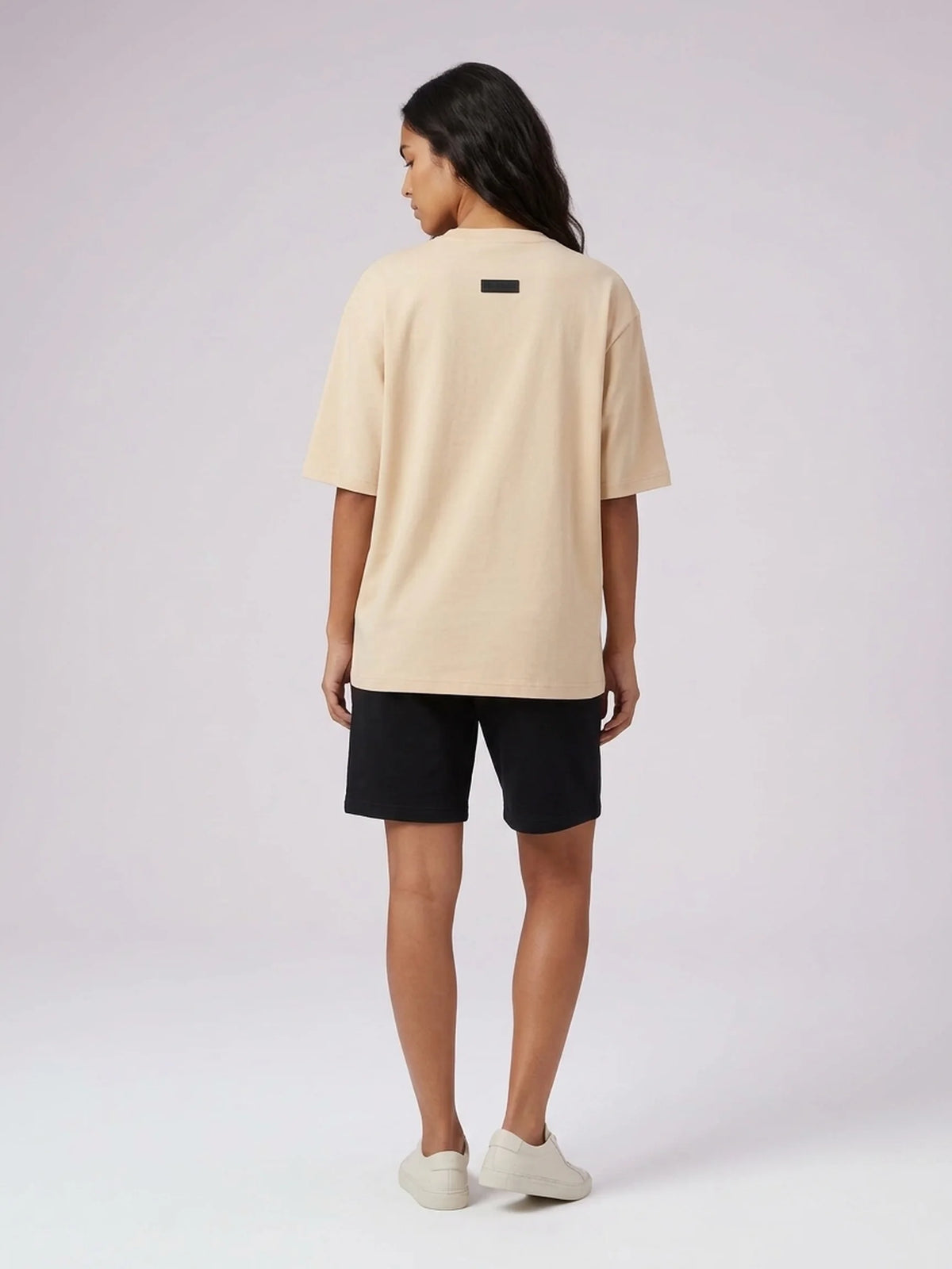Beige heavyweight oversized t-shirt, Unidentity Foundation Tee, full-length back view worn by woman with black Core shorts, sustainable fashion #color_beige