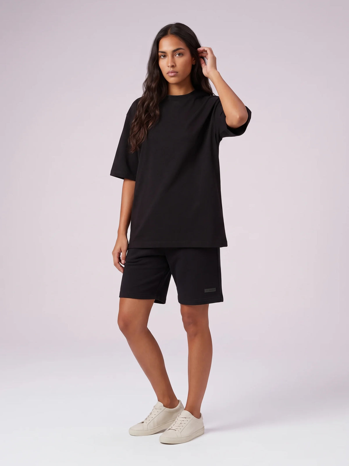 Black organic cotton t-shirt, Unidentity Foundation Tee, full-length front view of an all-black look with Core Regular Fit Shorts, sustainable fashion #color_black