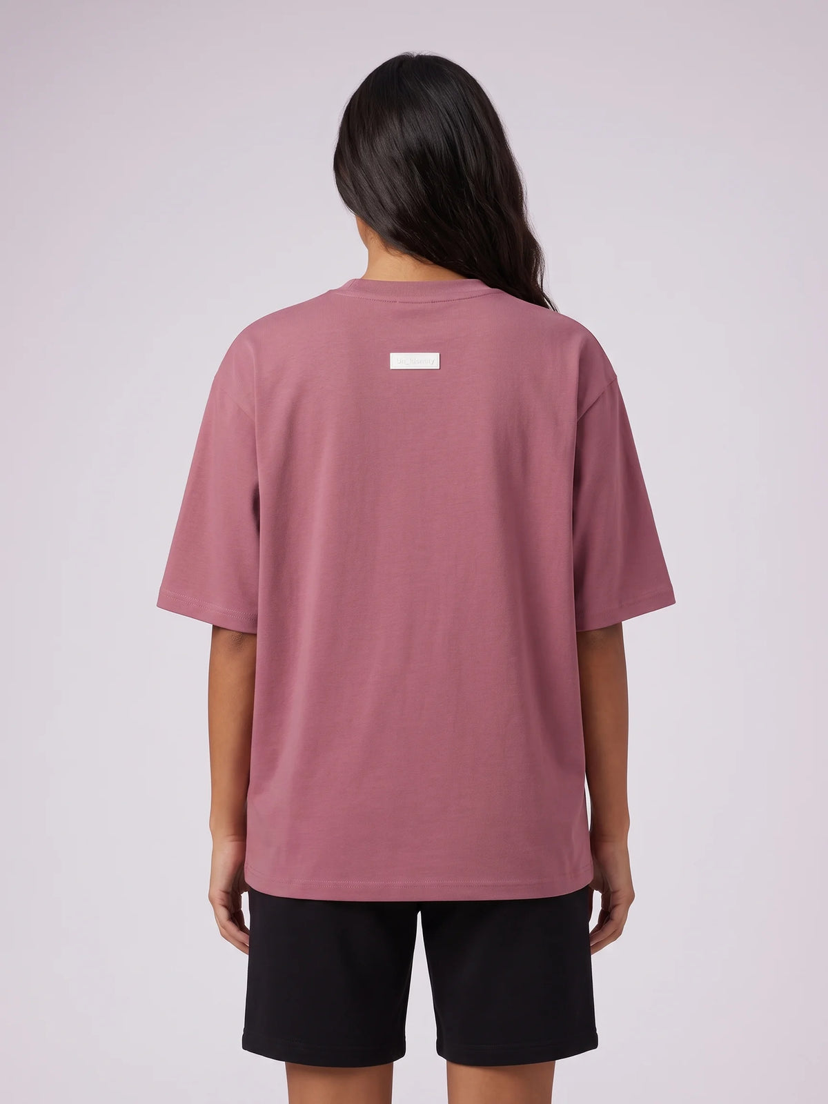 Plum oversized t-shirt, Unidentity Foundation Oversized Tee, upper back view worn by woman with the minimal white 3D patch, streetwear #color_plum