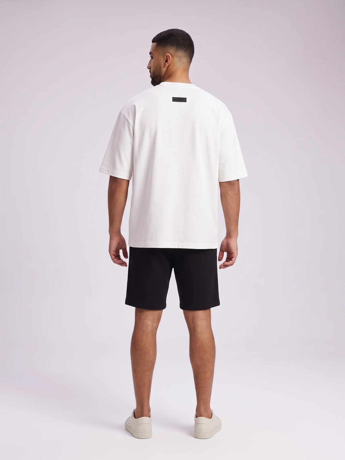 White heavyweight oversized t-shirt, Unidentity Foundation Tee, full-length back view of the boxy silhouette and 3D patch, sustainable streetwear #color_white