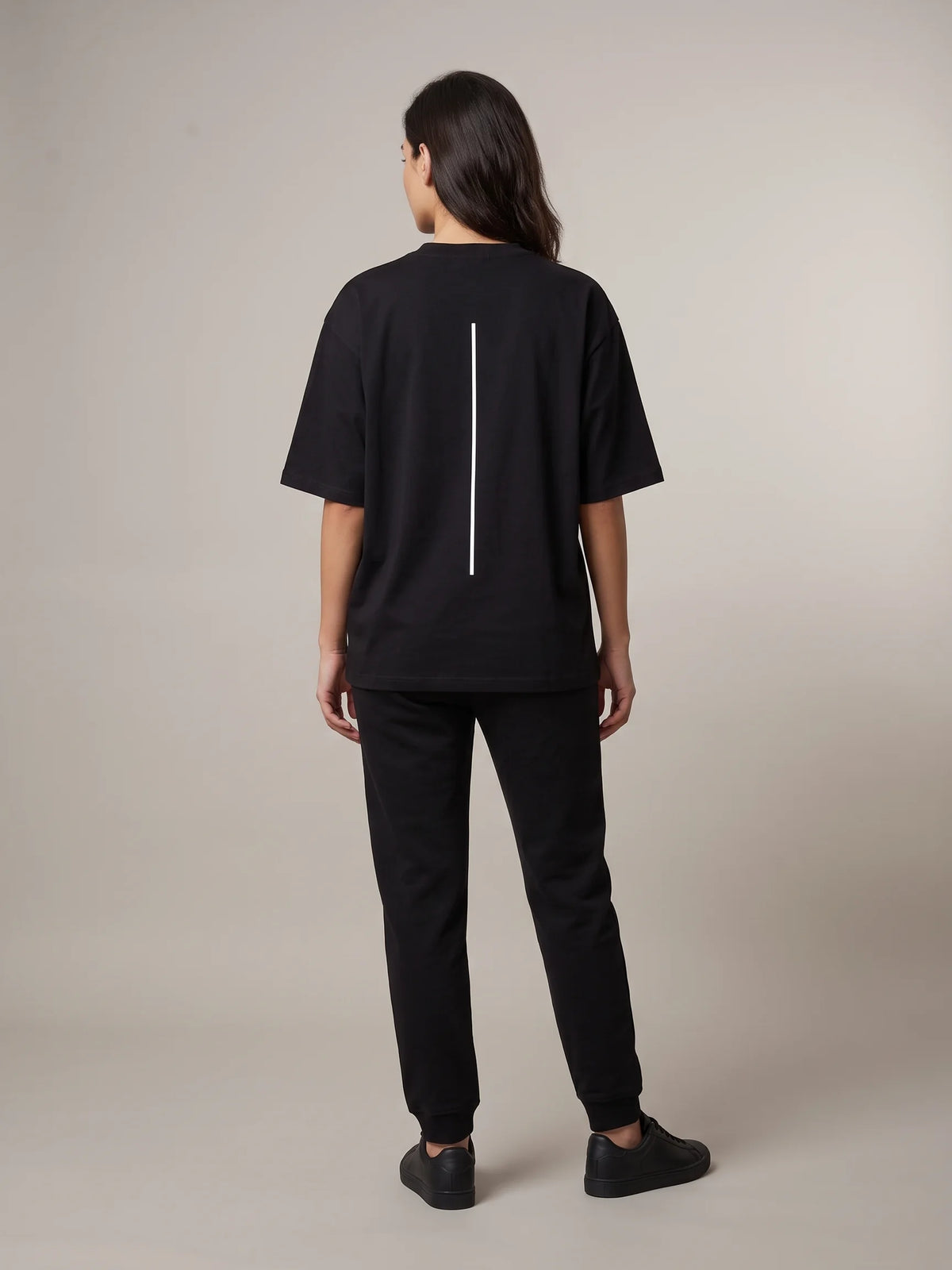 Black heavyweight oversized t-shirt, Unidentity Trace Tee, full-length back view worn by woman with vertical line print, sustainable fashion #color_black