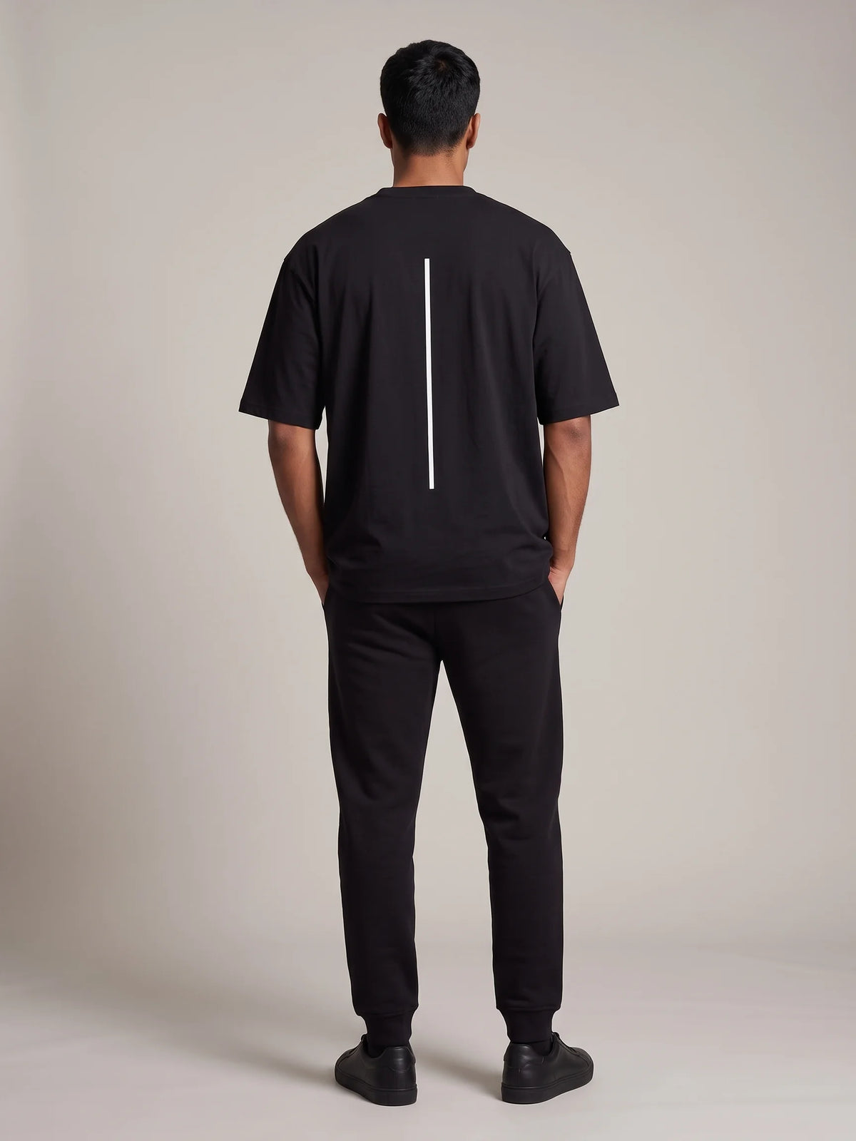 Black oversized t-shirt in organic cotton, Unidentity Trace Oversized Tee, full-length back view showing the relaxed fit, 210gsm streetwear #color_black
